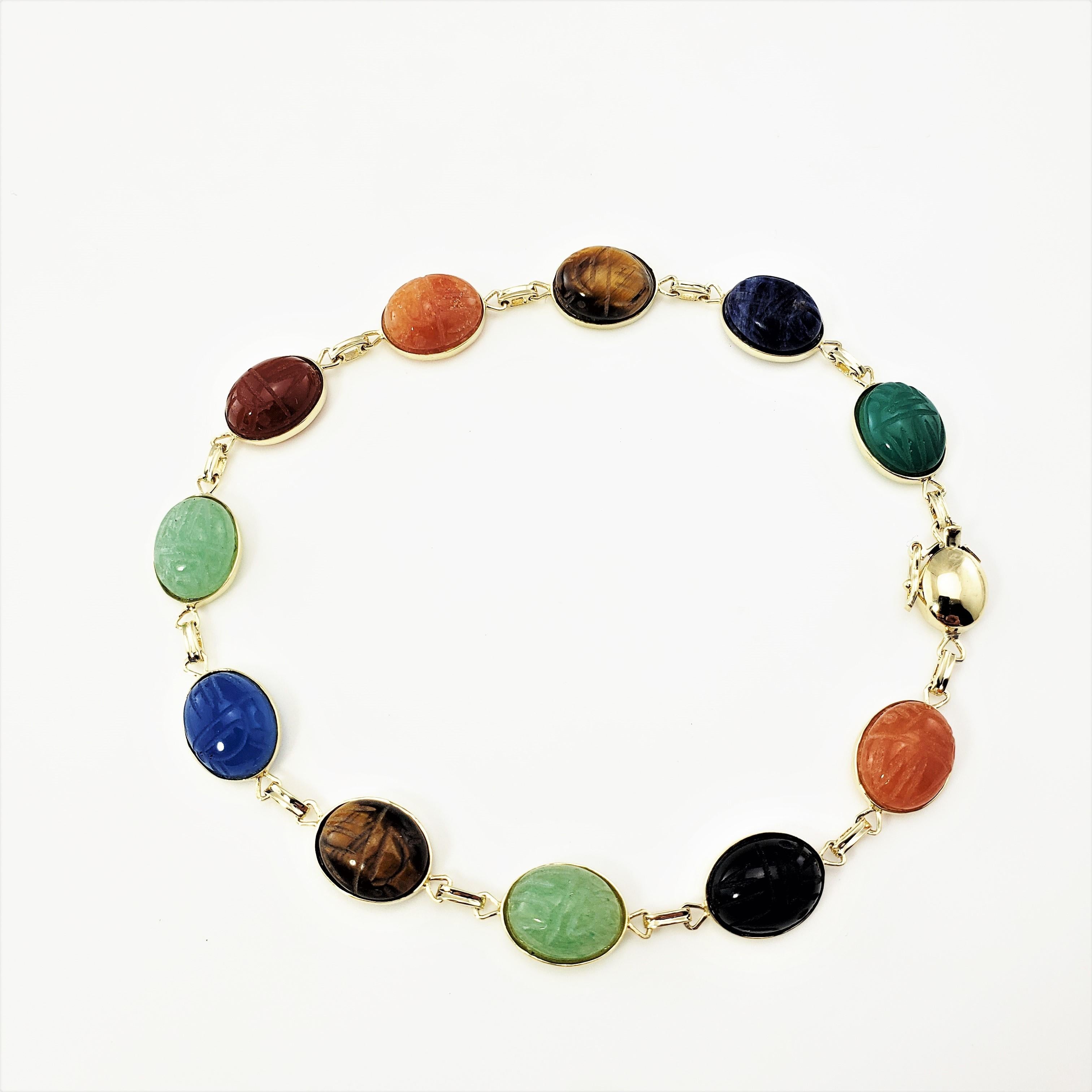 14 Karat Yellow Gold Scarab Bracelet-

This lovely scarab bracelet features 11 gemstones (jade, carnelian, lapis lazuli, onyx, tiger's eye) set in beautifully detailed 14K yellow gold.  Each stone measures 10 mm x 8 mm.

Size:  8.25 inches

Weight: 