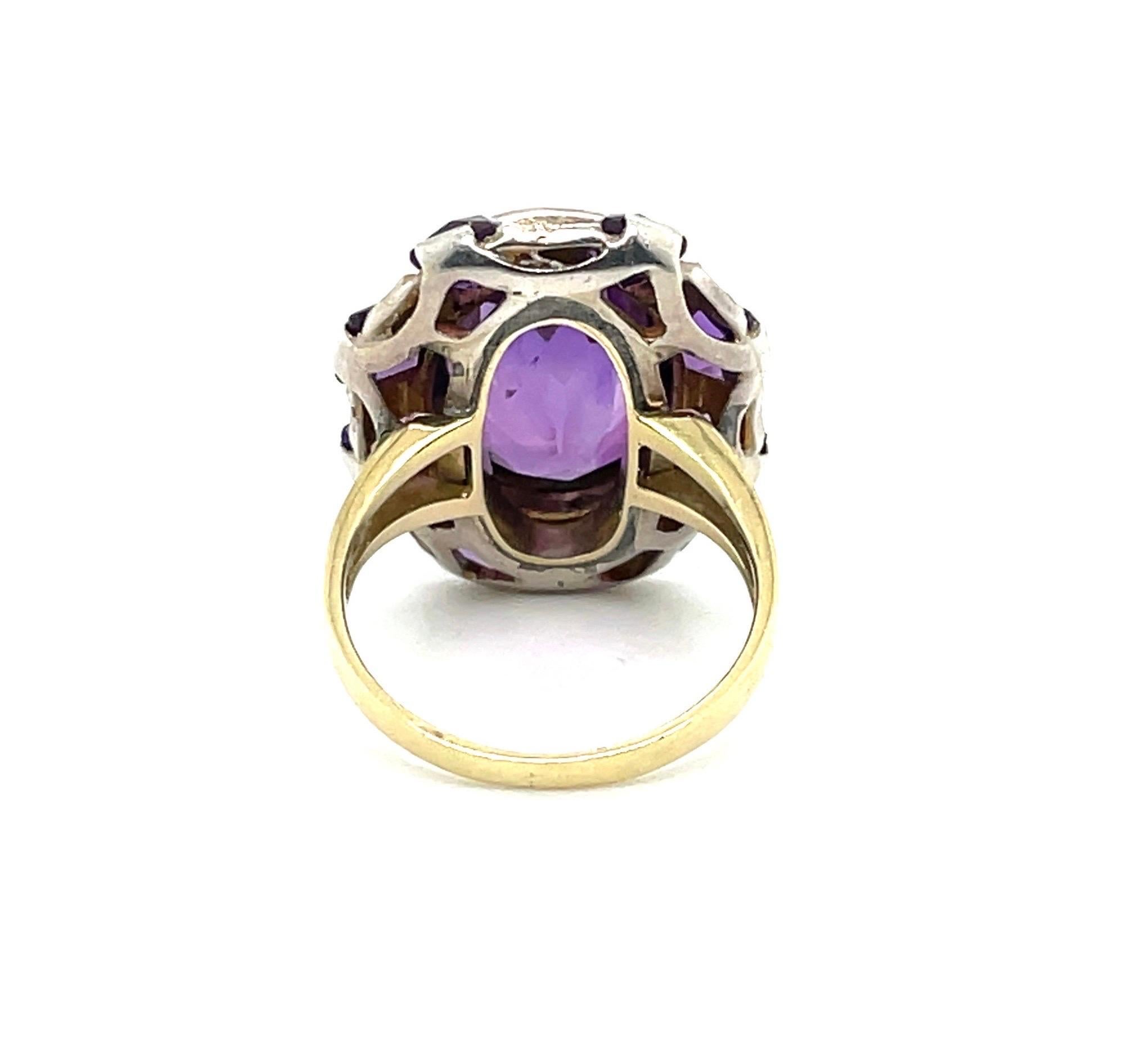 Decorative 14 karat yellow gold, silver, amethyst and seed pearl cocktail ring.

Eye-catching ring, centering upon an oval amethyst of circa 6.4 carats, within a millegrain-setting, alternatingly surrounded by 8 amethysts in French-cut, respectively