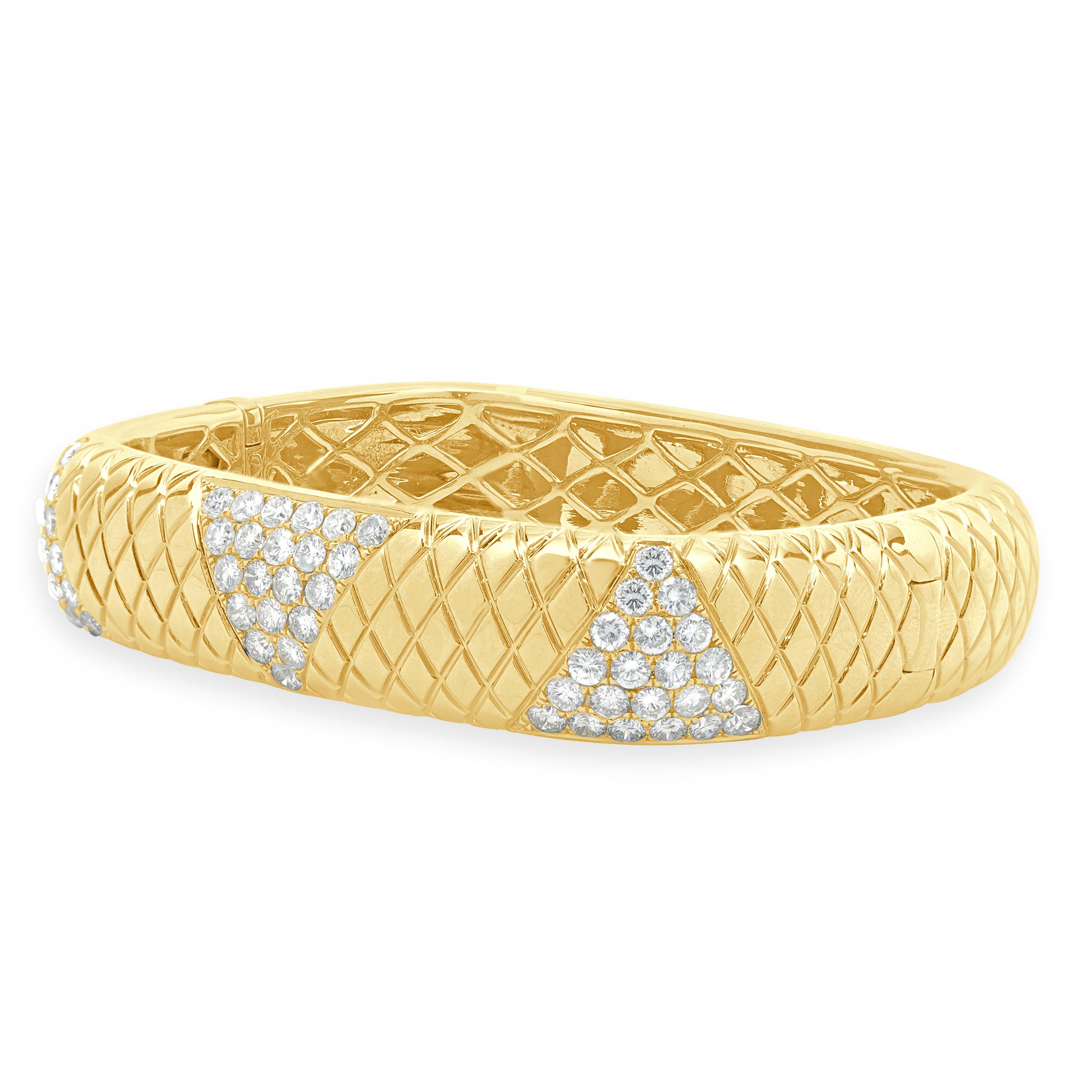 Designer: custom design
Material: 14K yellow gold
Diamond: 63 round brilliant cut = 4.25cttw
Color: G
Clarity: VS1-2
Dimensions: bracelet will fit up to a 7-inch wrist
Weight: 50.27 grams