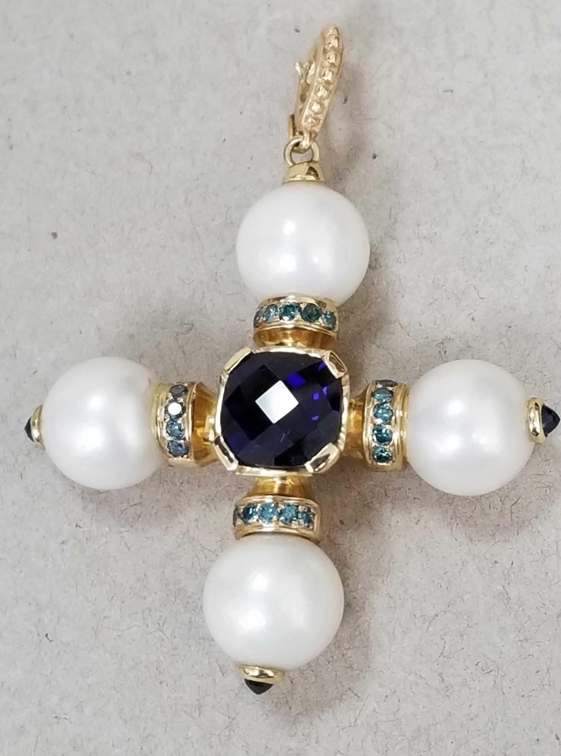 14k yellow gold South Sea Pearl cross with 4 pearls measuring 11-11.5mm, with a cushion cut iolite weighing 3.67cts. and 20 round full cut 