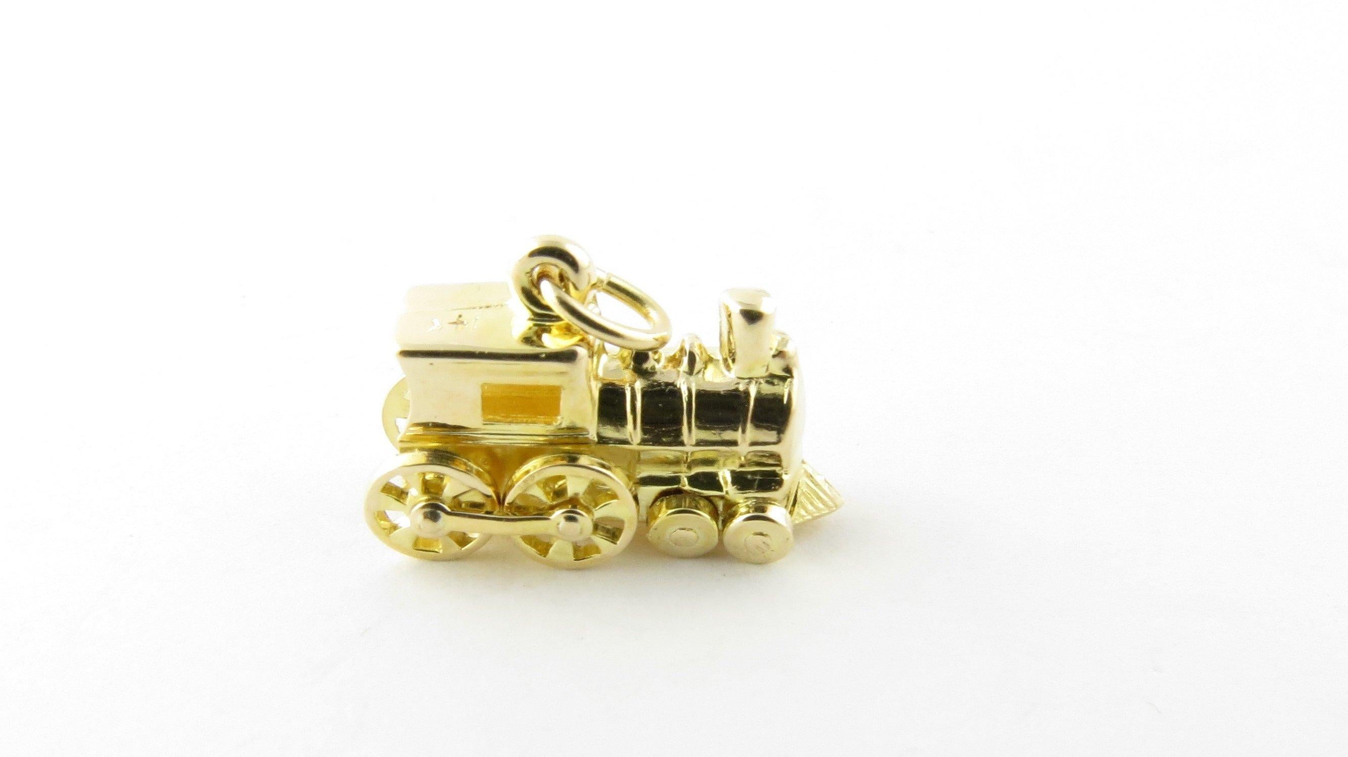 Vintage 14 Karat Yellow Gold Steam Engine Charm- This lovely 3D charm features a steam engine locomotive with moving wheels. Meticulously detailed in 14K yellow gold. Size: 12 mm x 16 mm (actual charm) Weight: 1.4 dwt. / 2.3 gr. Stamped: 14K Very