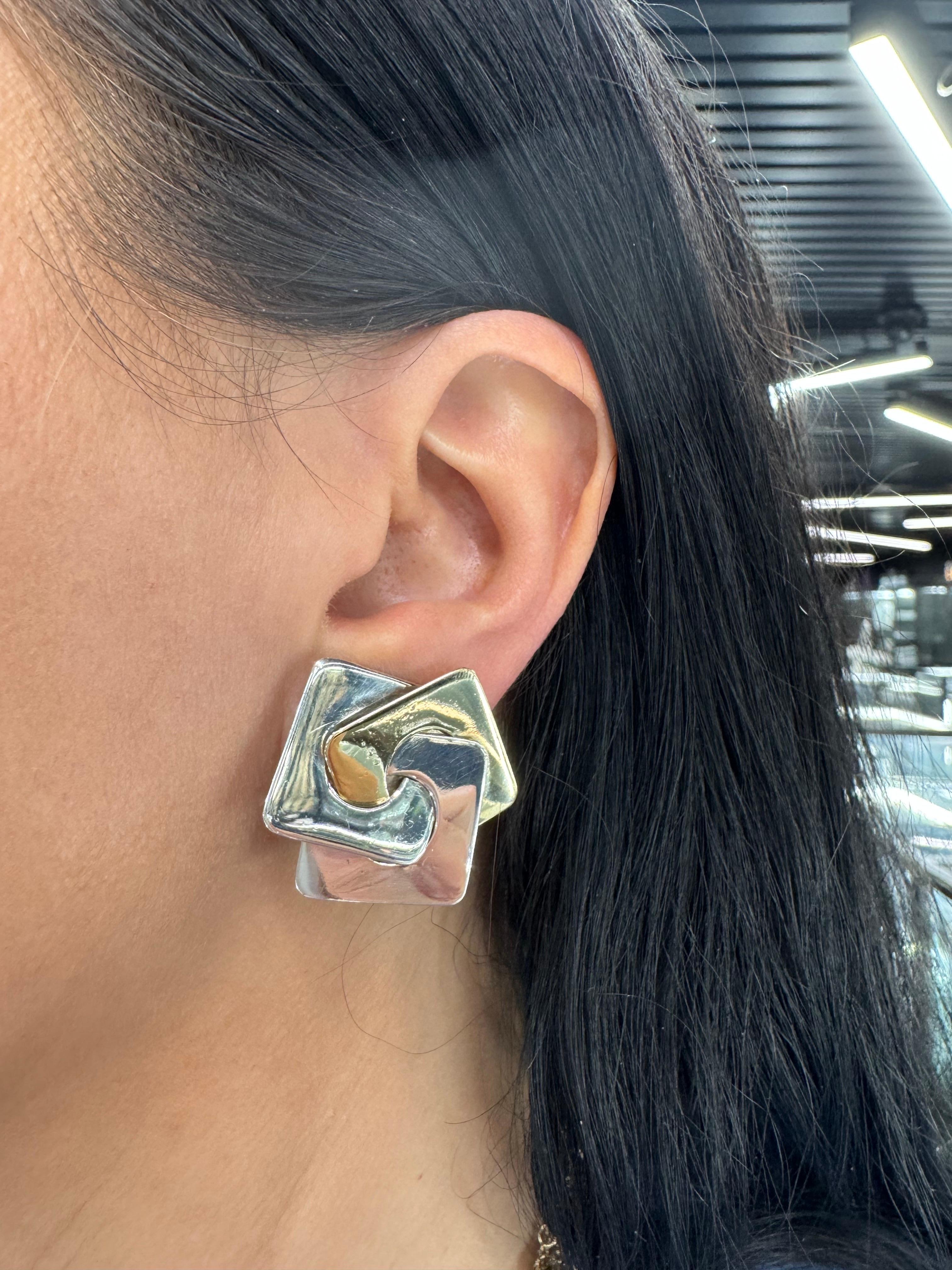 14 Karat Yellow Gold and Sterling Silver earrings featuring a geometric design weighing 17.1 Grams. 

Super Chic!!! 