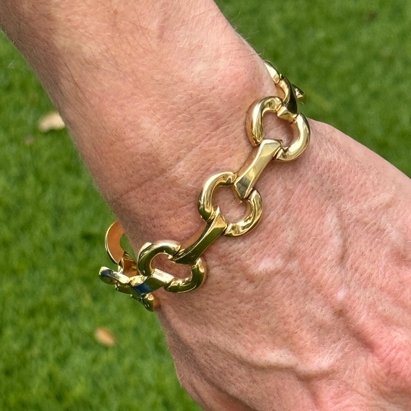 Modern stirrup link bracelet crafted in 14 karat yellow gold. The bracelet measures 7.25 inches in length, .70 inches in width and features a box clasp. Weight: 22.5 grams.