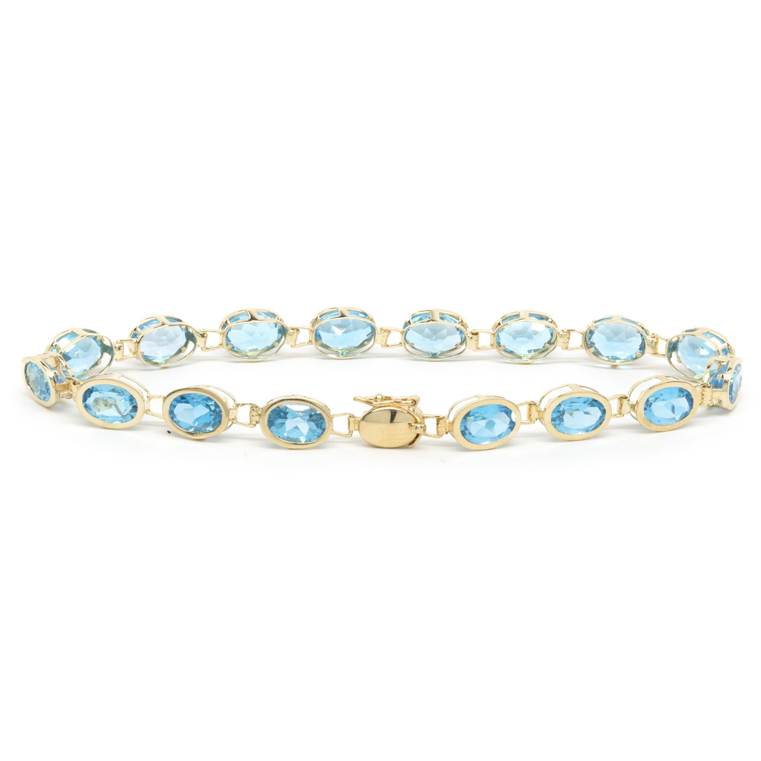 Designer: custom 
Material: 14K yellow gold
Blue Topaz: 16 oval cut = 13.00cttw
Color: Swiss Blue
Dimensions: bracelet will fit up to a 7-inch wrist
Weight: 6.90 grams
