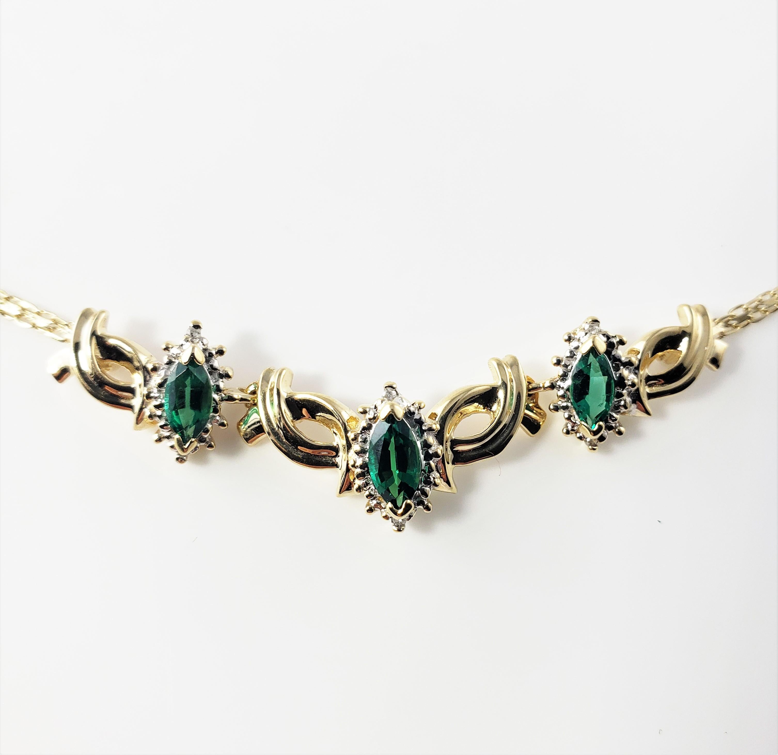 14 Karat Yellow Gold Simulated Emerald and Diamond Necklace-

This lovely necklace features three marquis simulated emeralds (6 mm x 3 mm each) and six round singe cut diamonds set in beautifully detailed 14K yellow gold.  Spring ring