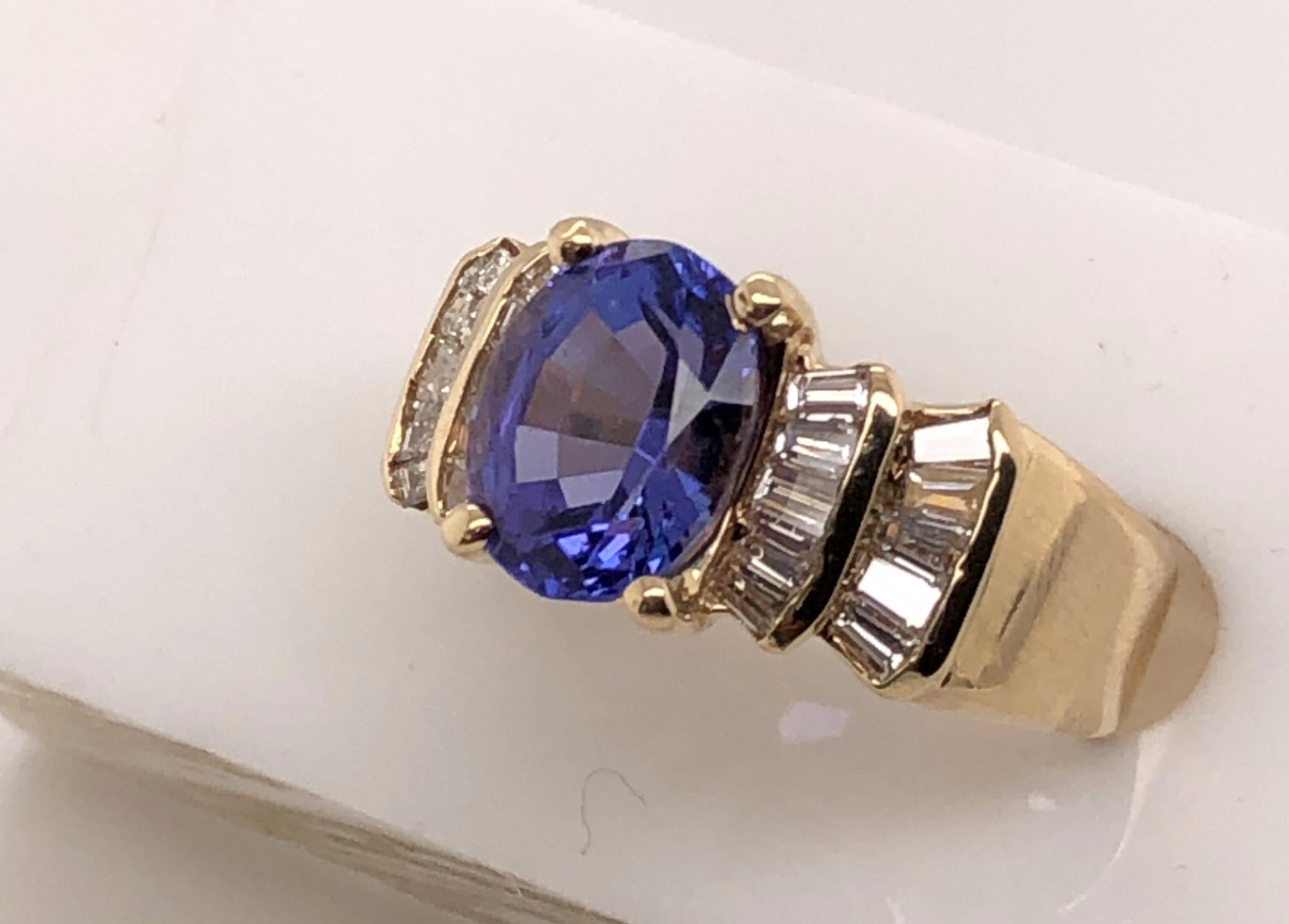 14 Karat Yellow Gold Ring with a 2.75 carat oval Tanzanite centered between two rows of Diamond Baguettes.

The Diamonds are .60 Total Carat Weight J-K color SI-1 SI-2 Clarity.

The Tanzanite measures approximately 1/4 inch x 3/8 inch.  It sits 1/4
