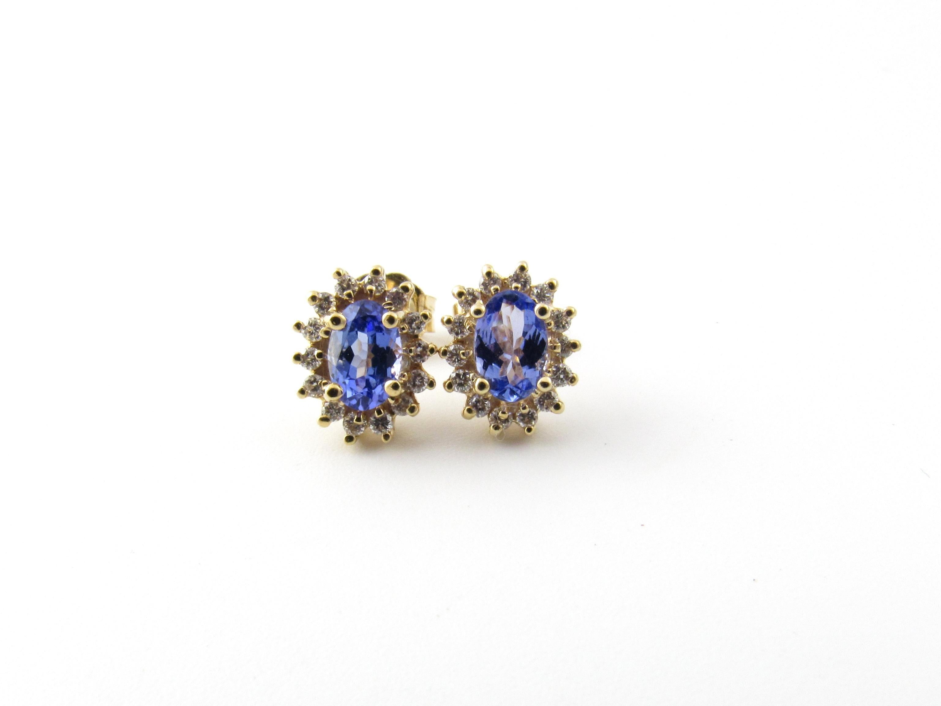 Vintage 14 Karat Yellow Gold Tanzanite and Diamond Earrings

These sparkling earrings each feature one oval tanzanite (6 mm x 4 mm) surrounded with 14 round brilliant cut diamonds set in classic 14K yellow gold. Push back closures.

Approximate