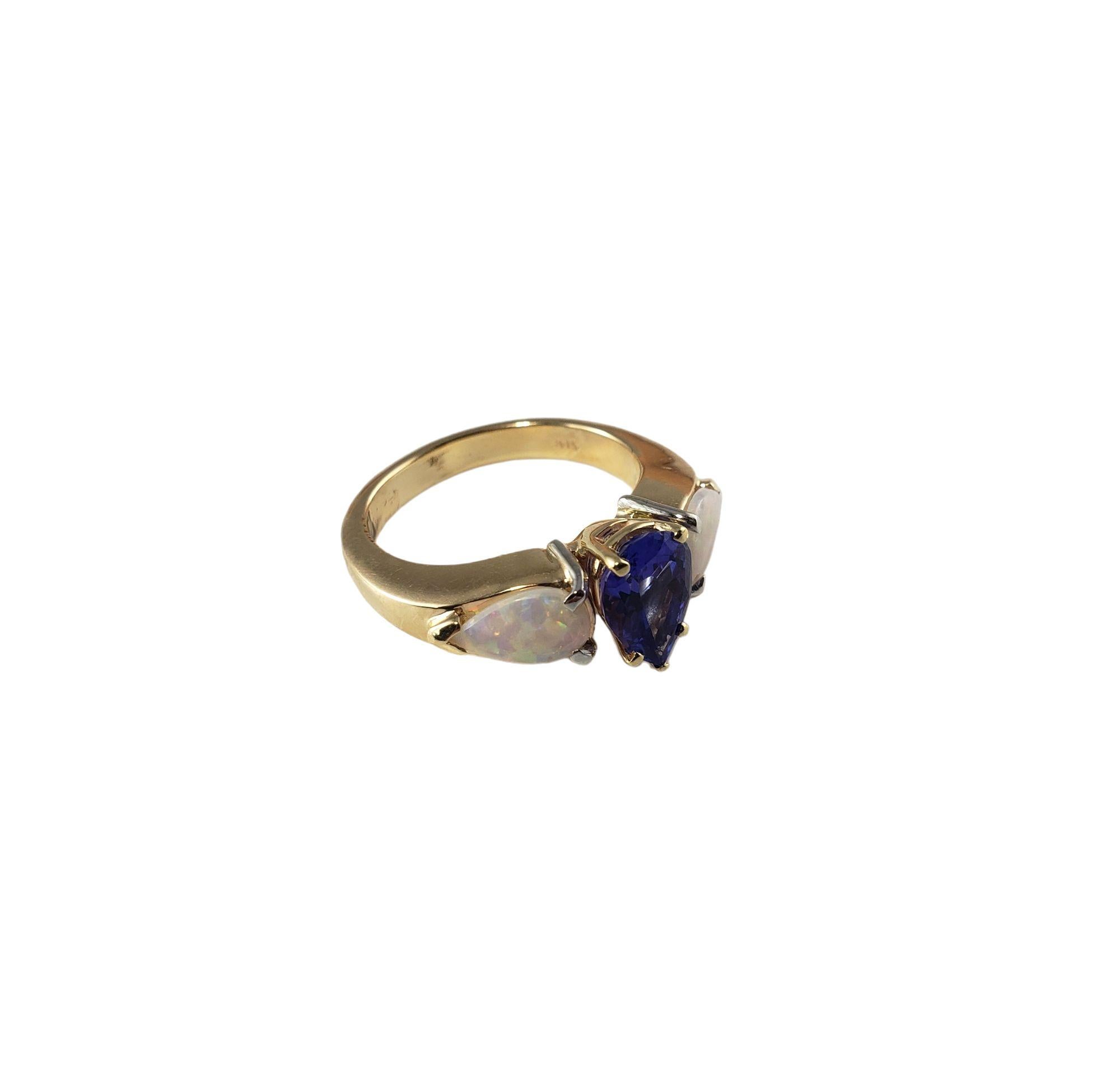 Vintage 14 Karat Yellow Gold Tanzanite and Opal Ring Size 7.25-7.5 JAGi Certified-

This lovely ring features one pear shaped tanzanite (9 mm x 6 mm) and two cabochon pear shaped white opals (8 mm x 5 mm) set in classic 14K yellow gold. Shank: 3
