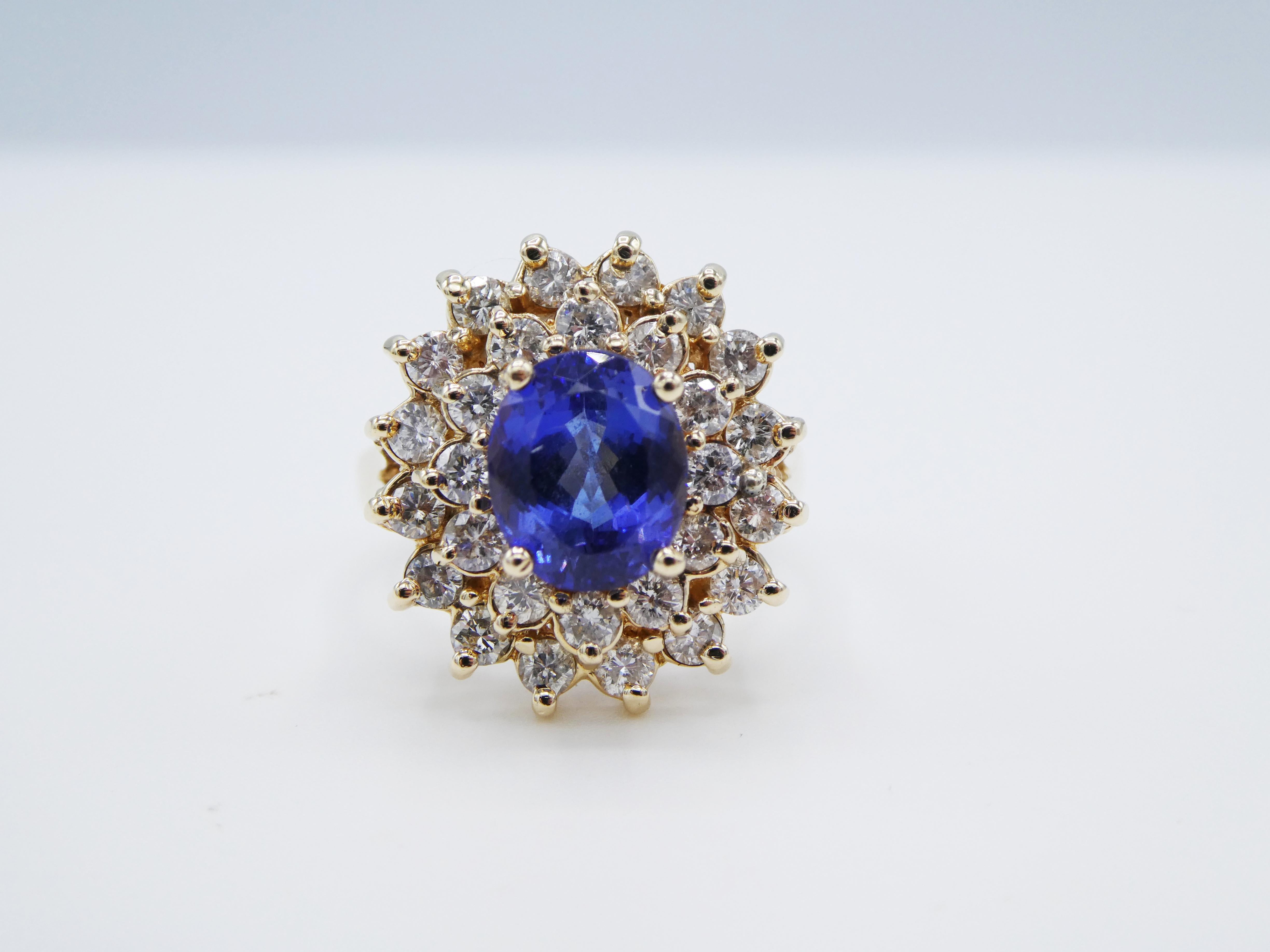 14 Karat Yellow Gold Tanzanite & Diamond Halo Cocktail Ring Size 6.75 
Metal: 14k yellow gold
Weight:6.97 grams
Diamonds: Approx. 1.50 CTW H-I VS-SI
Tanzanite: 8.5 x 7.2 x 5.2 approx. 2 carats 
Top of ring measures 18 x 16.5MM
Size: 6.75 (US)
Band