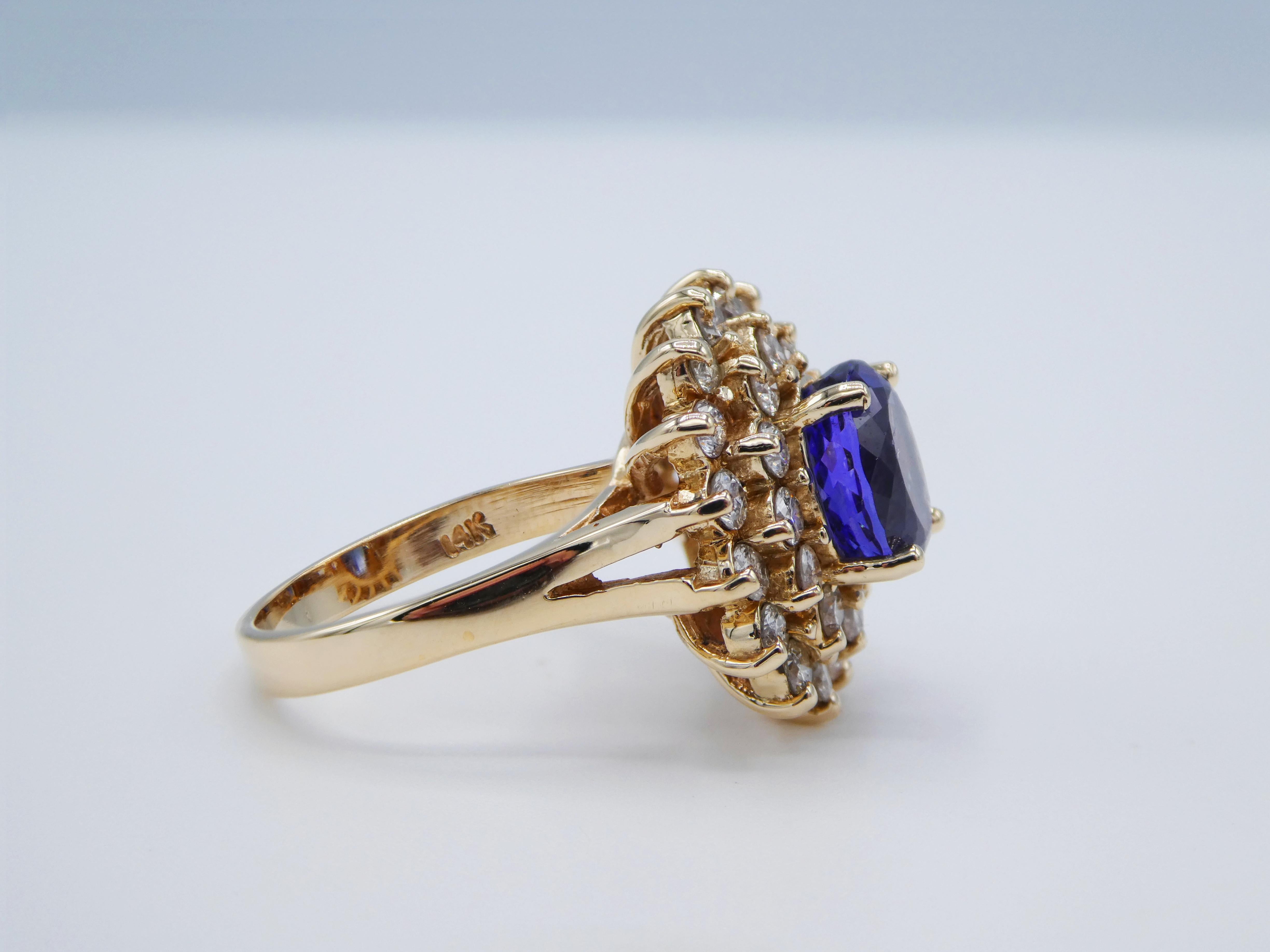 Modern 14 Karat Yellow Gold Tanzanite and Diamond Halo Cocktail Ring