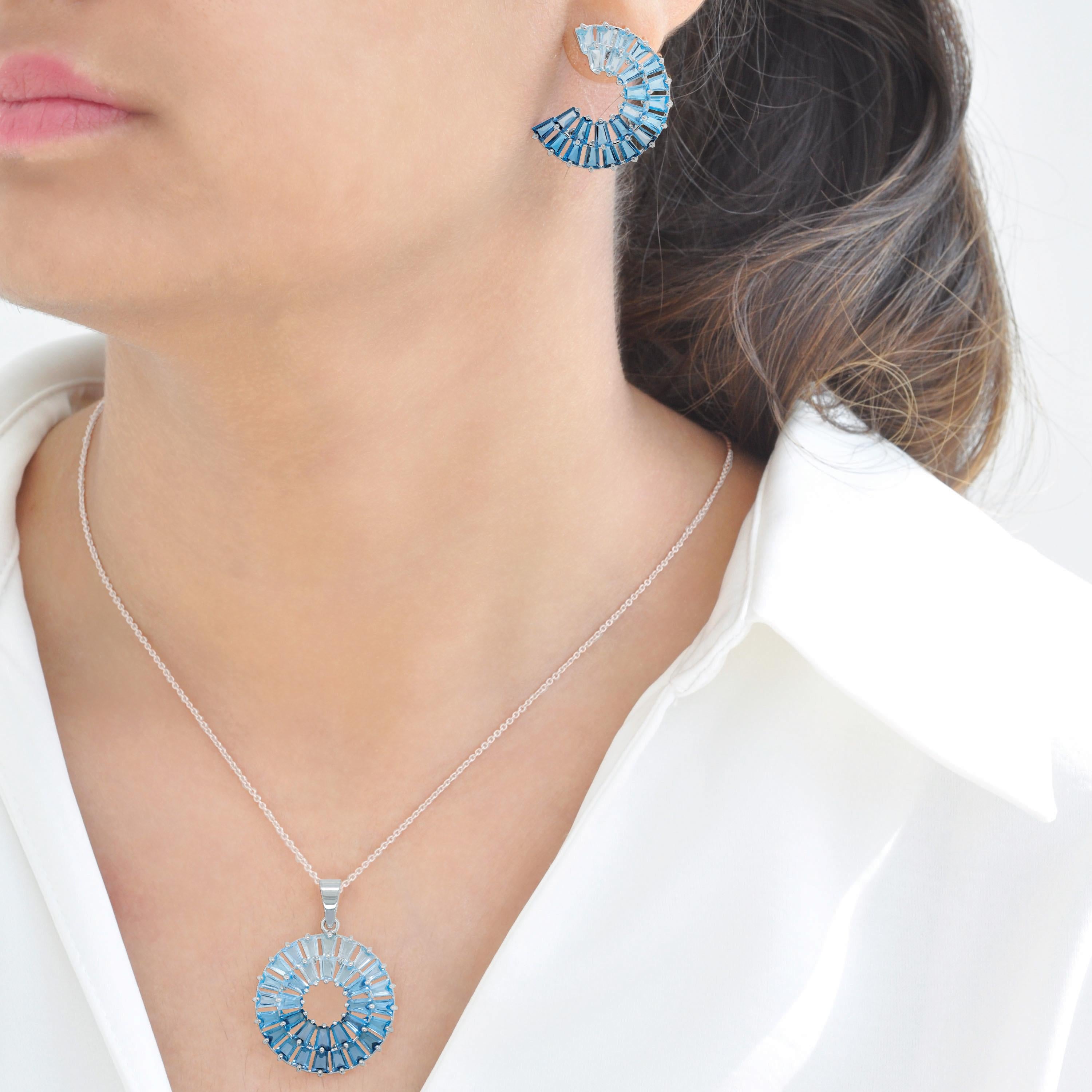 Blue Topaz Three-Quarter Circle Earrings & Pendant in 14K White Gold

Immerse yourself in the captivating brilliance of blue topaz with this exquisite matching set, featuring stud earrings and a pendant crafted in 14-karat white gold. Designed for