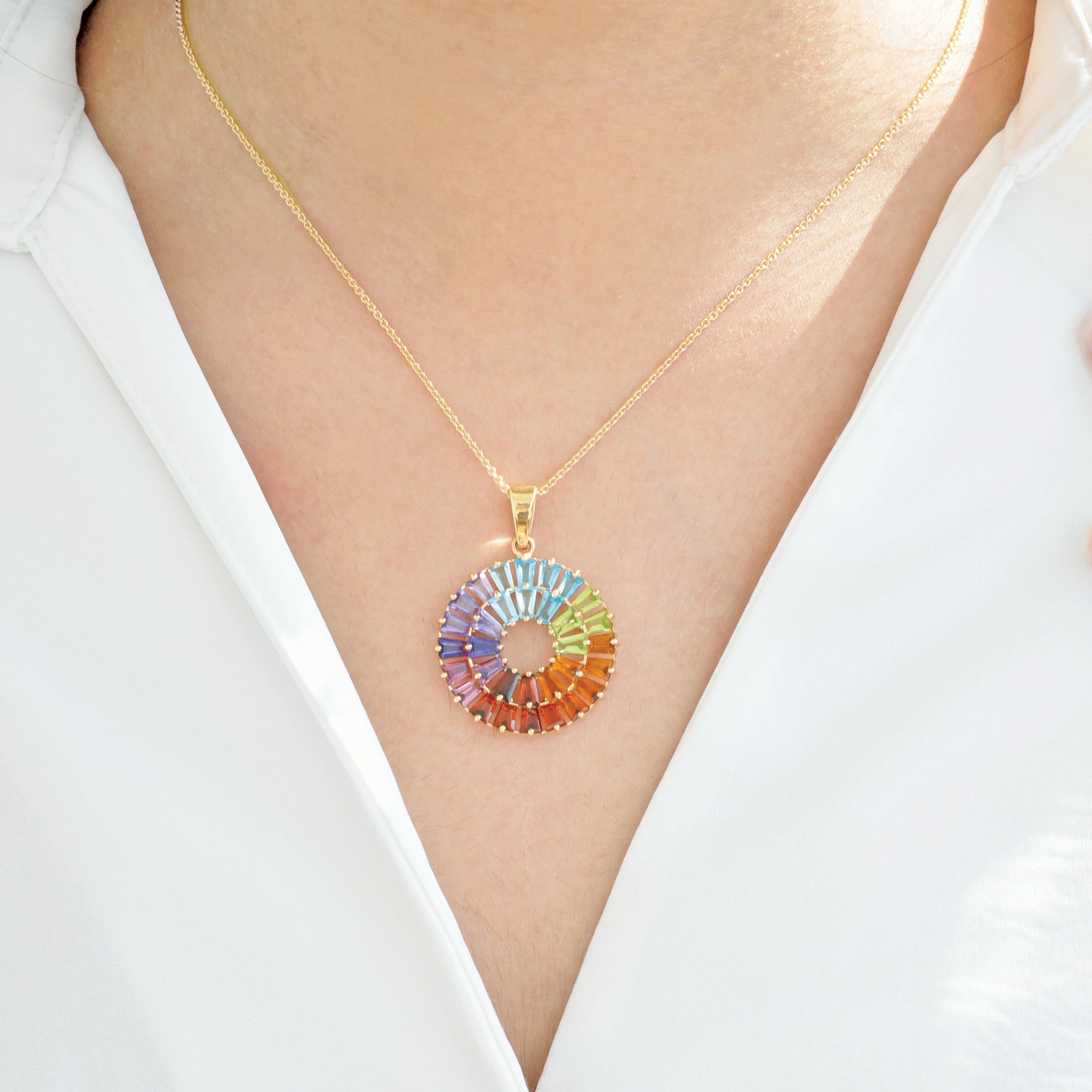 This exquisite pendant is handcrafted in 14-karat yellow gold and showcases a vibrant array of multicolored natural gemstones, making it a true celebration of color and elegance. The design features 32 carefully selected tapered baguette-cut gems