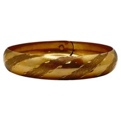 14 Karat Yellow Gold, Tension Lock Hidden Clasp, Diamond Cut Bangle