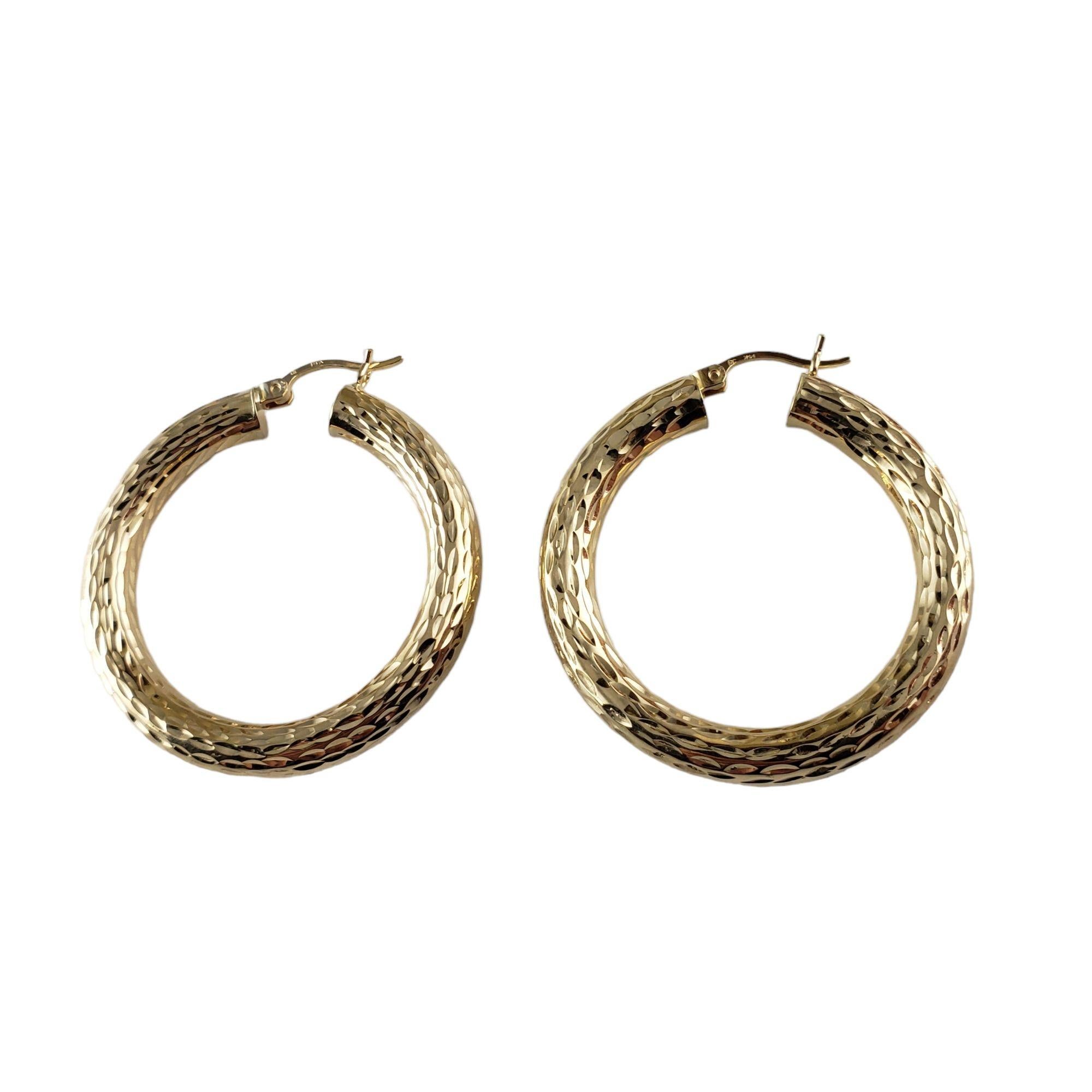 These lovely textured hoop earrings are crafted in beautifully detailed 14K yellow gold.

Size: 34 mm x 5 mm

Weight: 3.4 gr./ 2.2 dwt.

Stamped: 14K

Very good condition, professionally polished.

Will come packaged in a gift box or pouch and will