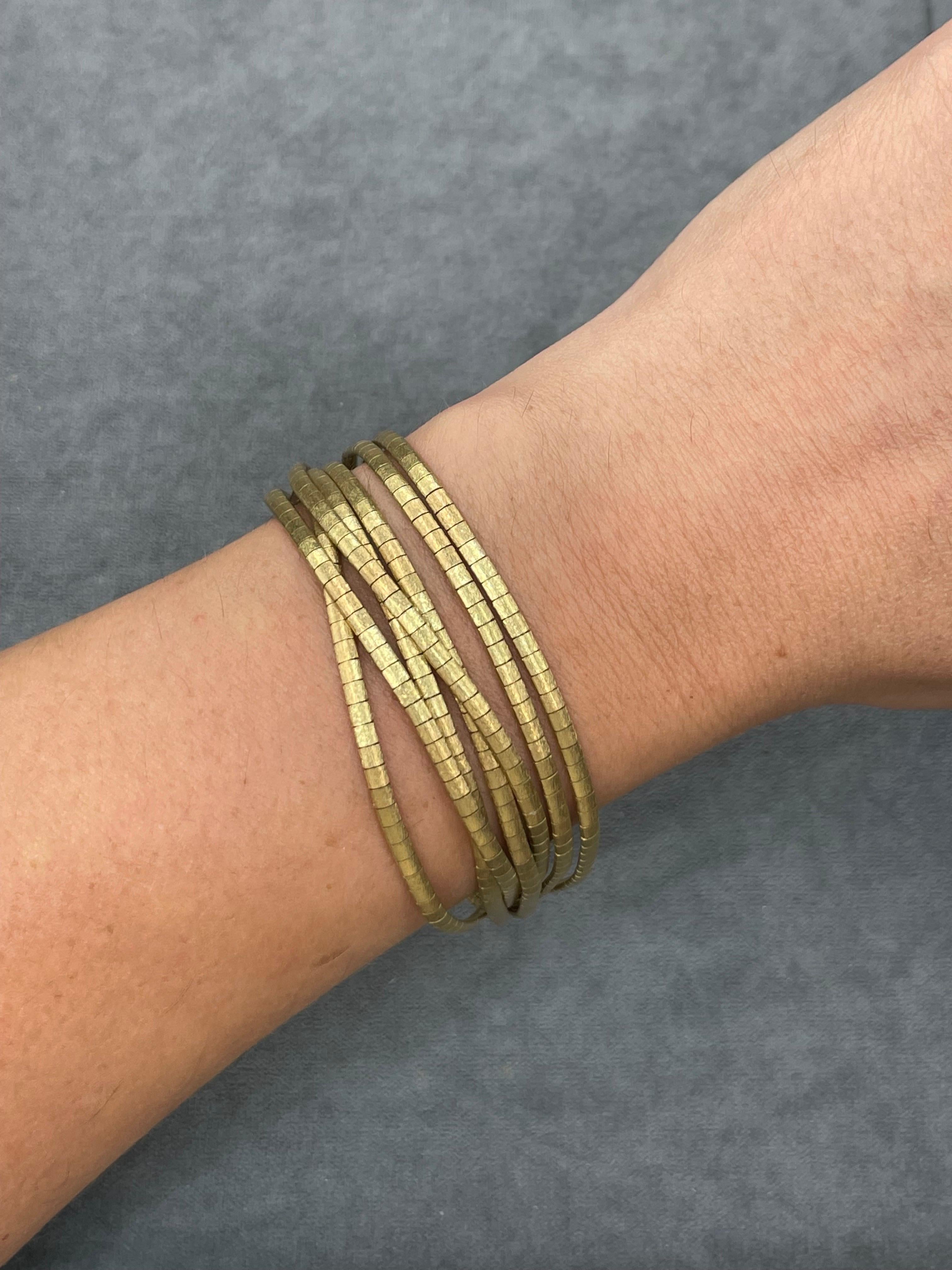 14 karat yellow gold bracelet features 7 multi textured strands weighing 49.8 grams.
Each strand is 2.5 mm wide
Feels like silk! 

Available in 18 Karat yellow gold bracelet & matching necklace. 
Search Harbor Diamonds for more gold link bracelets.

