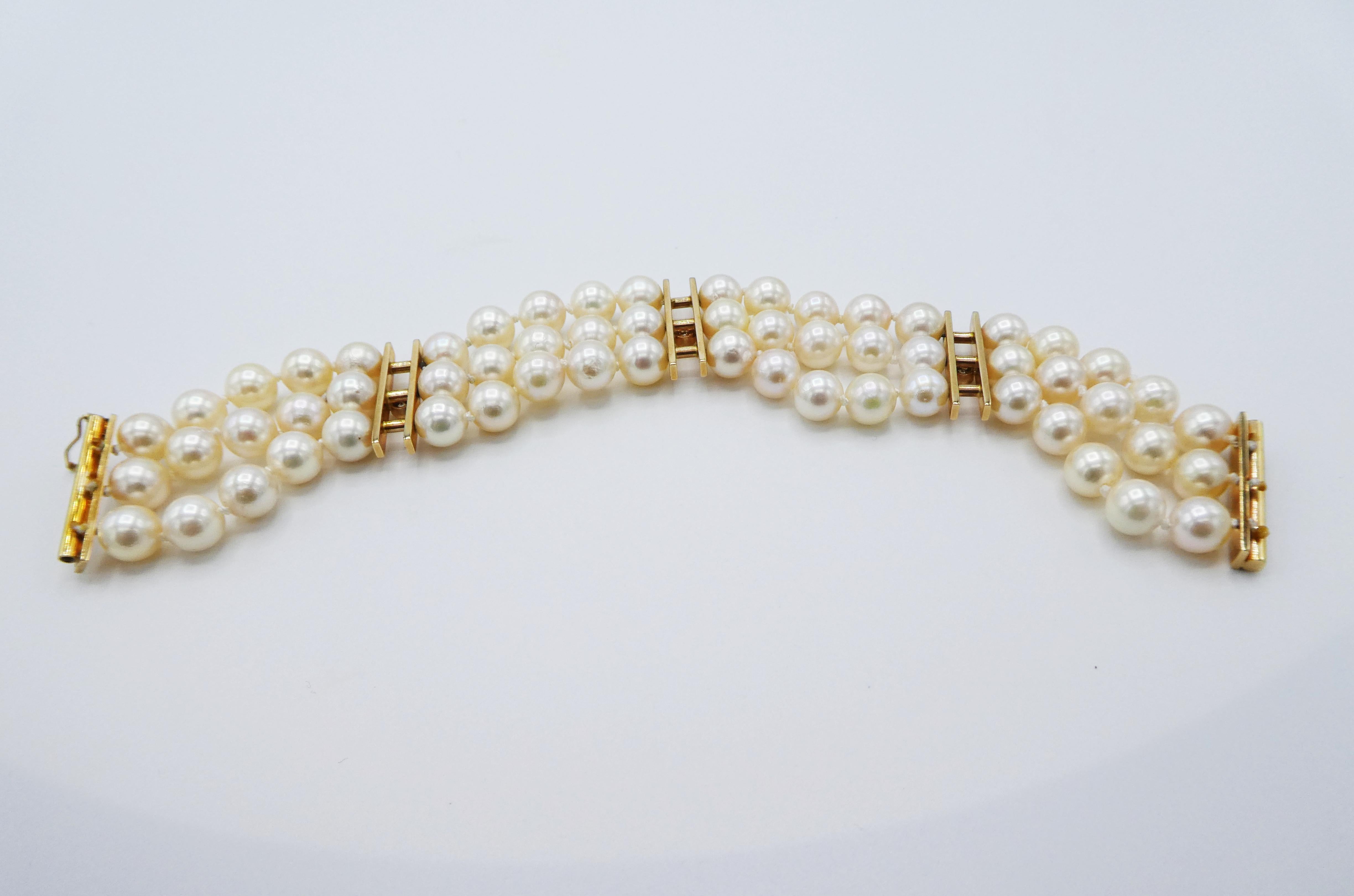 14 Karat Yellow Gold Three Row Multi Strand Cultured Pearl & Diamond Bracelet
Metal: 14k yellow gold
Weight: 34.2 grams
Diamonds: 3 round brilliant cut diamonds, approx. .20 CTW G VS
Pearls: Cultured, 6.8MM white with a creamy luster 
Length: 6.5