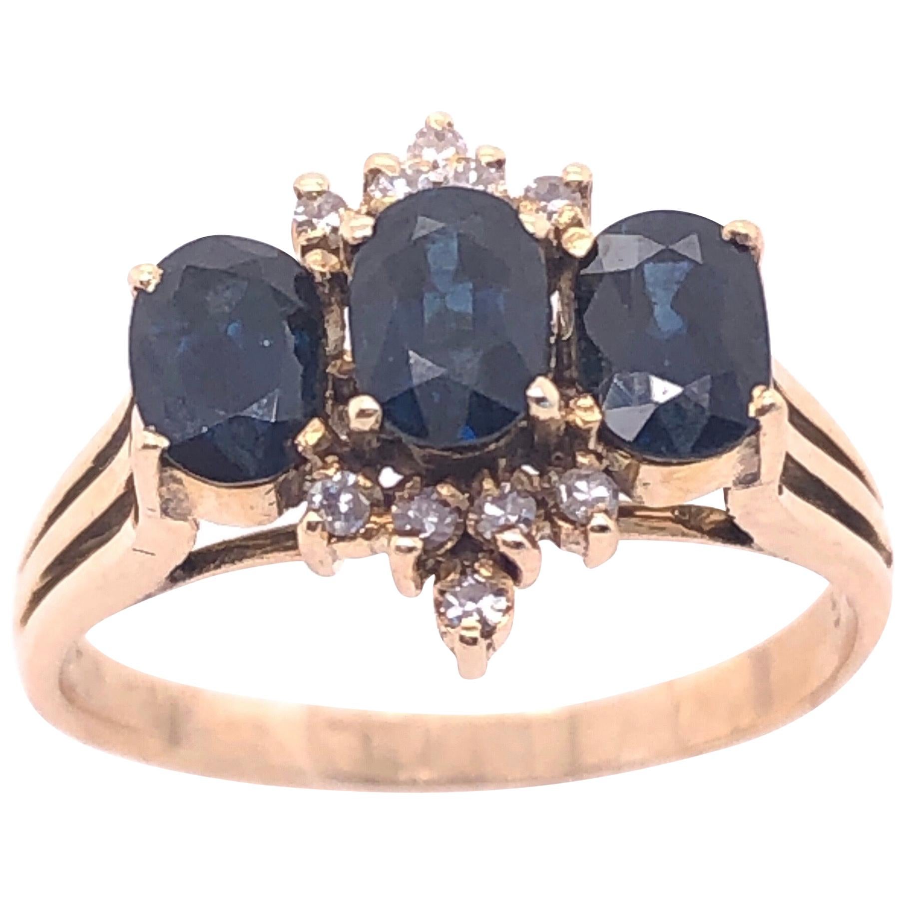 14 Karat Yellow Gold Three-Stone Sapphire Ring with Diamond Accents