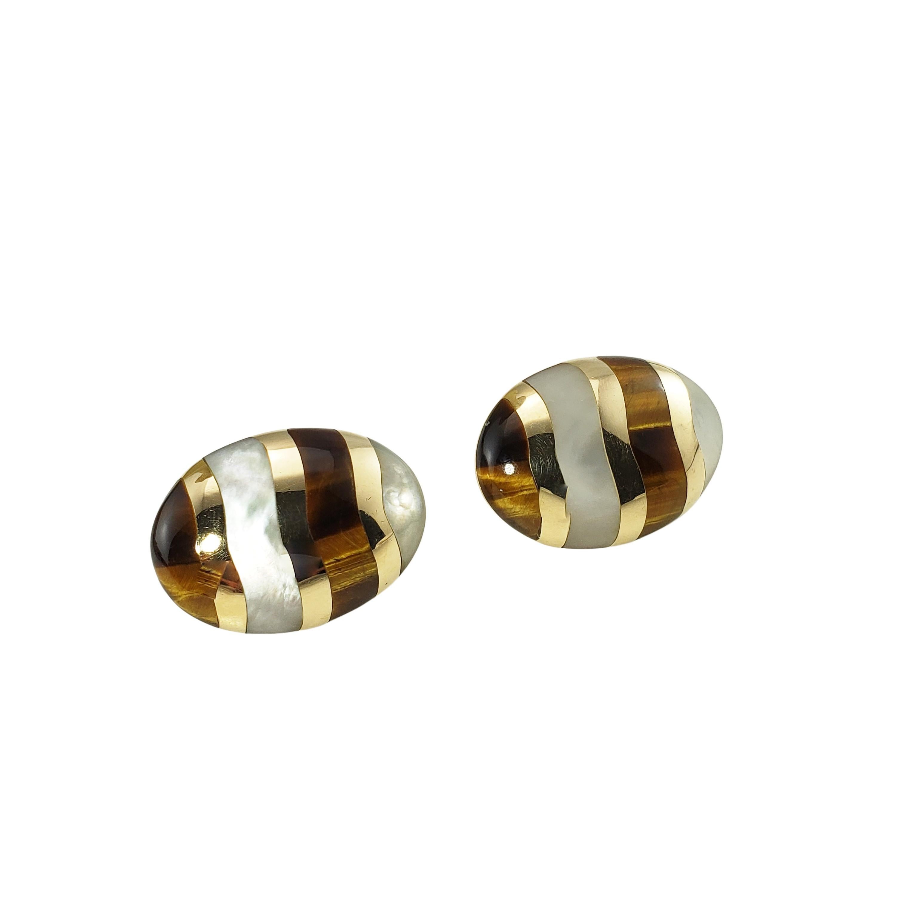 14 Karat Yellow Gold Tiger's Eye and Mother of Pearl Earrings-

These lovely earrings each features tiger's eye and mother of pearl set in beautifully detailed 14K yellow gold.

Size: 29 mm x 21 mm 

Weight:  11.7 dwt. /  18.3 gr.

Stamped: 14K