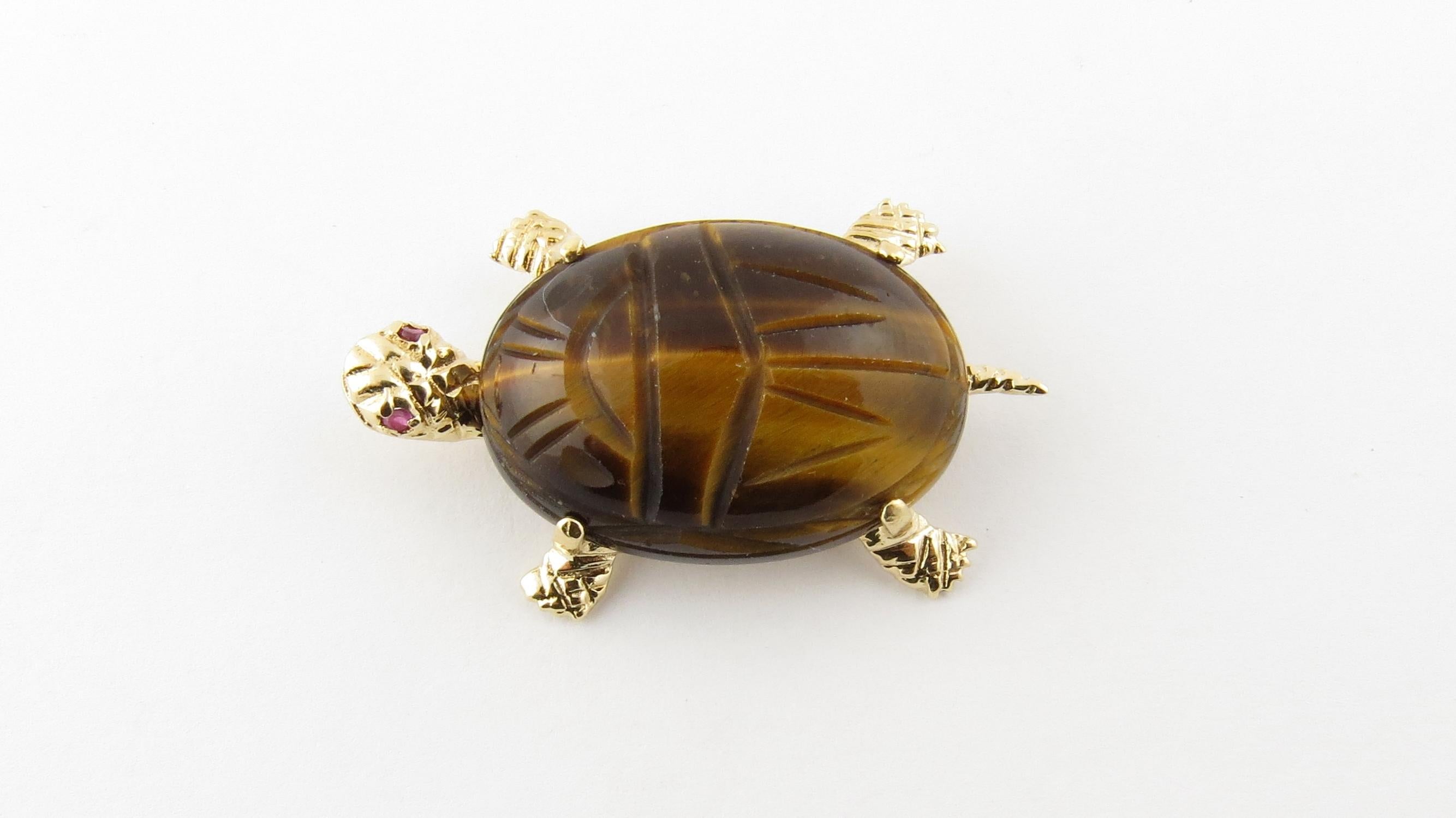 Vintage 14 Karat Yellow Gold Tiger's Eye and Ruby Turtle Brooch / Pin

This lovely turtle brooch features one oval tiger's eye scarab (25 mm x 18 mm) and two genuine ruby eyes set in beautifully detailed 14K yellow gold.

Size: 36 mm x 22