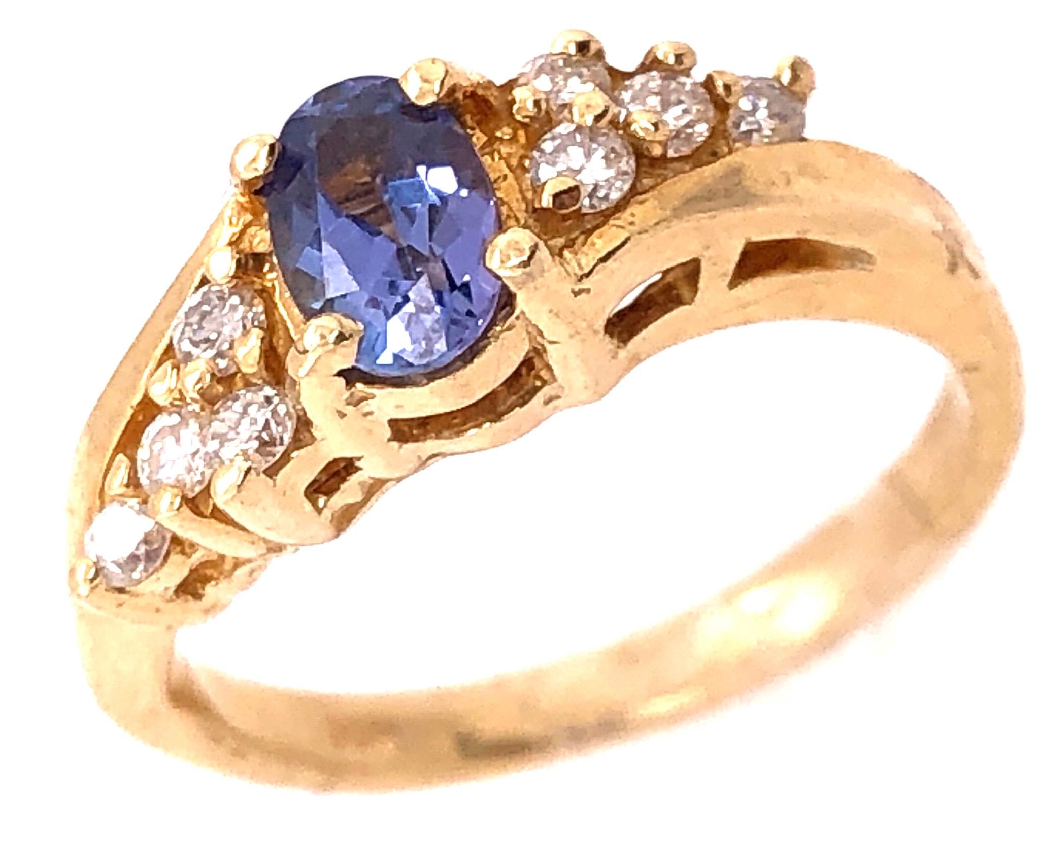 14 Karat Yellow Gold Contemporary Topaz Ring with Round Diamonds 0.20 TDW 
Size 5 
4 grams total weight.
