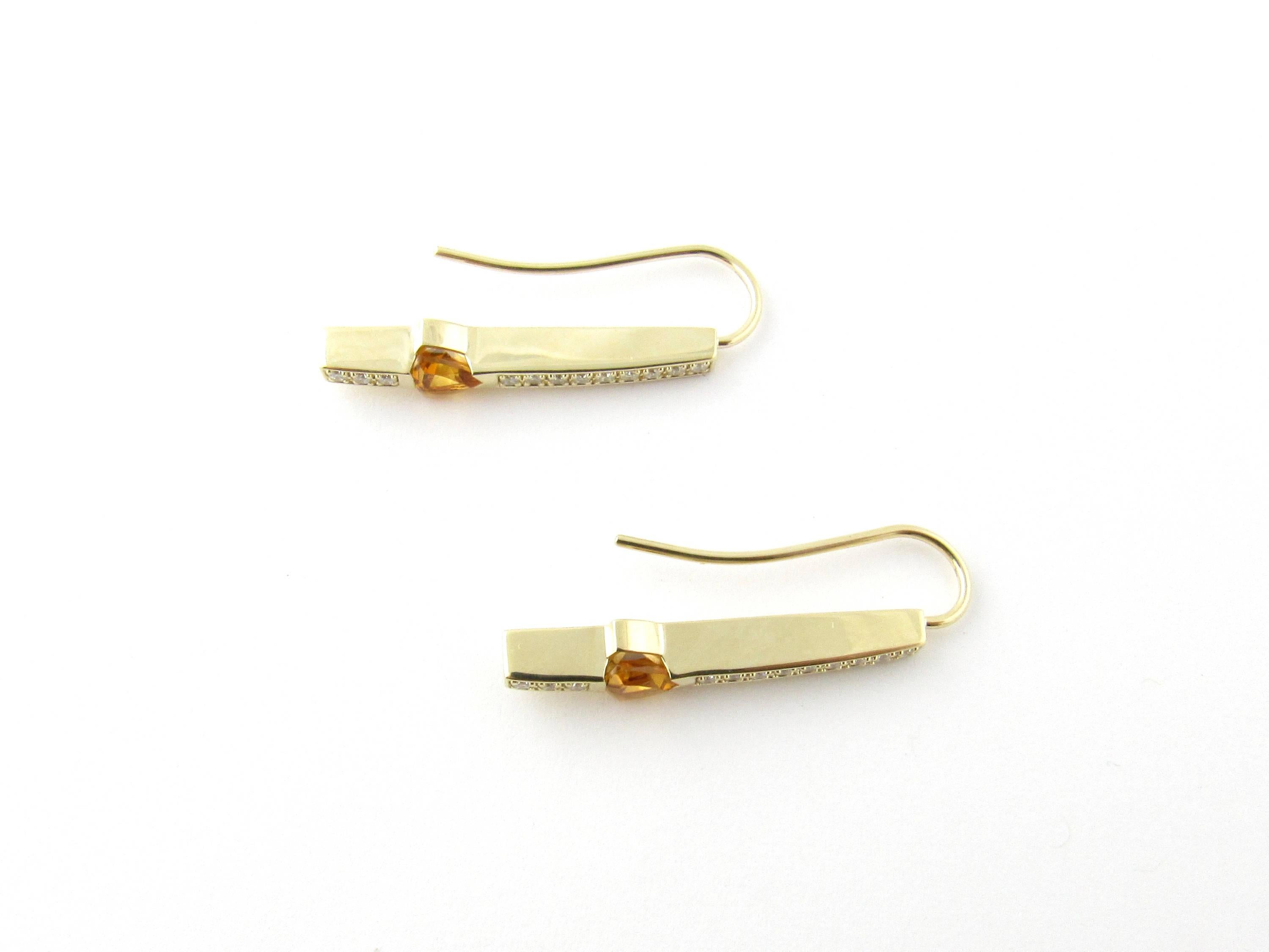 Vintage 14 Karat Yellow Gold Topaz and Diamond Earrings- 
These lovely earrings each feature 12 round brilliant cut diamonds accented with a trillion cut topaz (5 mm x 5 mm) set in 14K yellow gold. Fish hook closures. 
Approximate total diamond