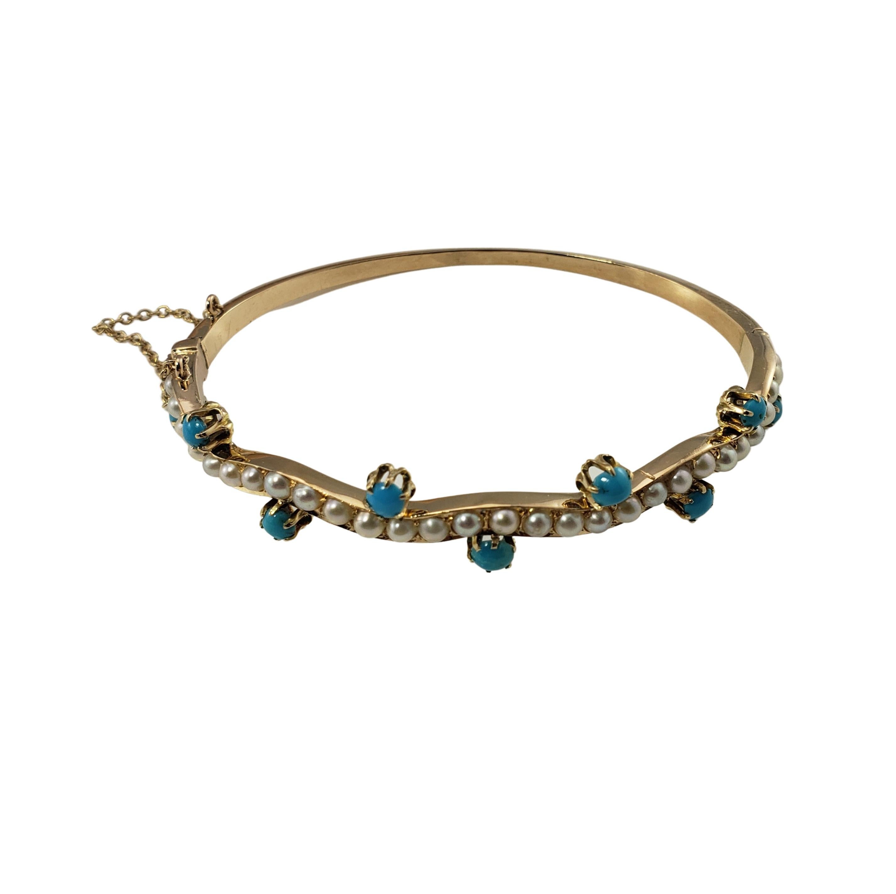 14 Karat Yellow Gold Turquoise and Seed Pearl Bangle Bracelet-

This lovely hinged bangle bracelet features nine round turquoise stones and 29 white seed pearls set in beautifully detailed 14K yellow gold.  Width:  4 mm.

Size: 6.75 inches

Weight: 