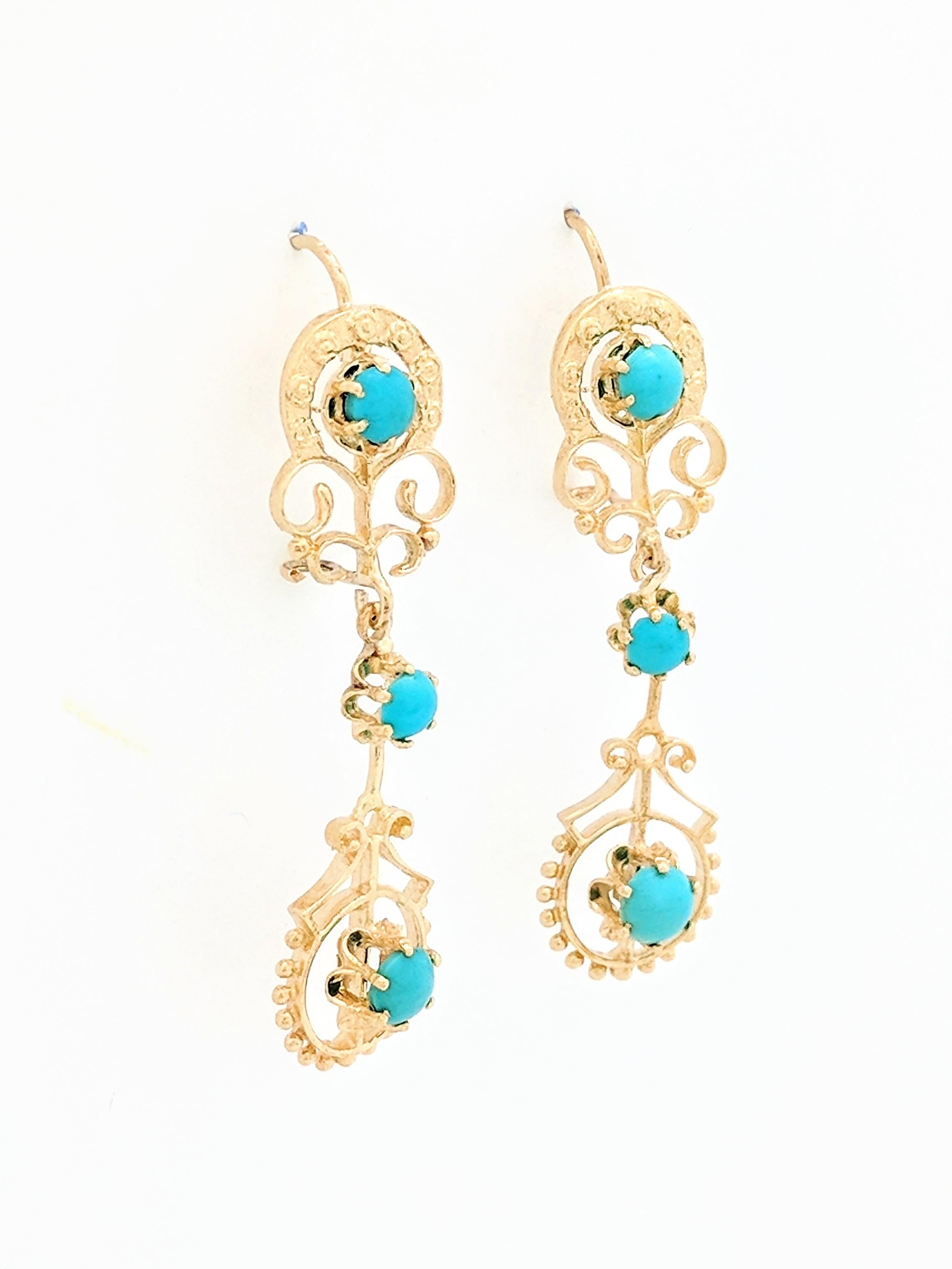 You are viewing a beautiful pair of turquoise dangle earrings. These earrings are crafted from 14k yellow gold and weighs 6.7 grams. Each earring features (3) cabochon turquoise gemstones. These earrings feature a kidney wire closure and are