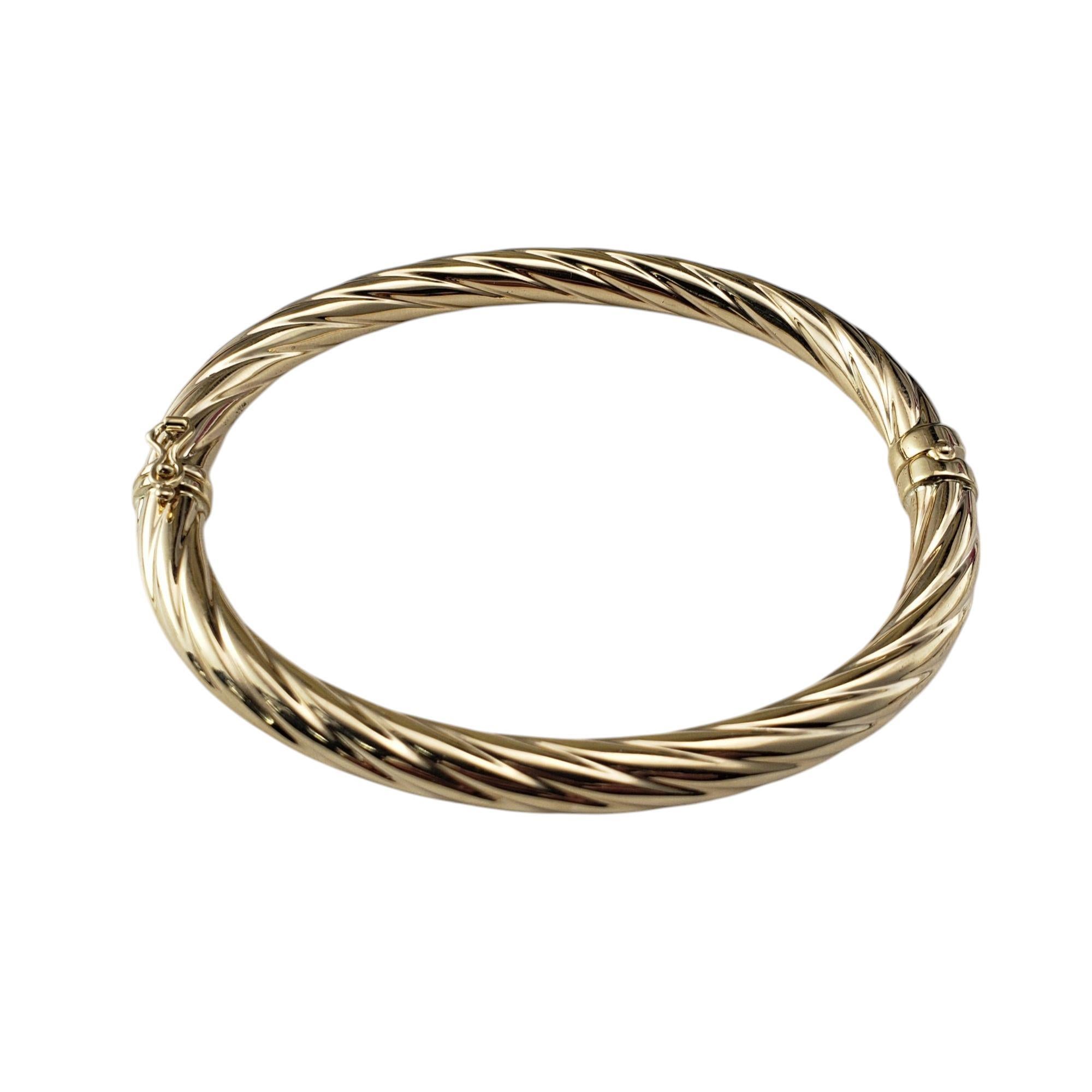 14 Karat Yellow Gold Twist Bangle Bracelet-

This elegant bangle bracelet features a graceful twist design crafted in radiant 14K yellow gold. Hinged closure. Width: 6 mm.

Size: 7.25 inches

Weight: 4.7 dwt./ 7.4 gr.

Stamped: 14KT ITALY

Very good