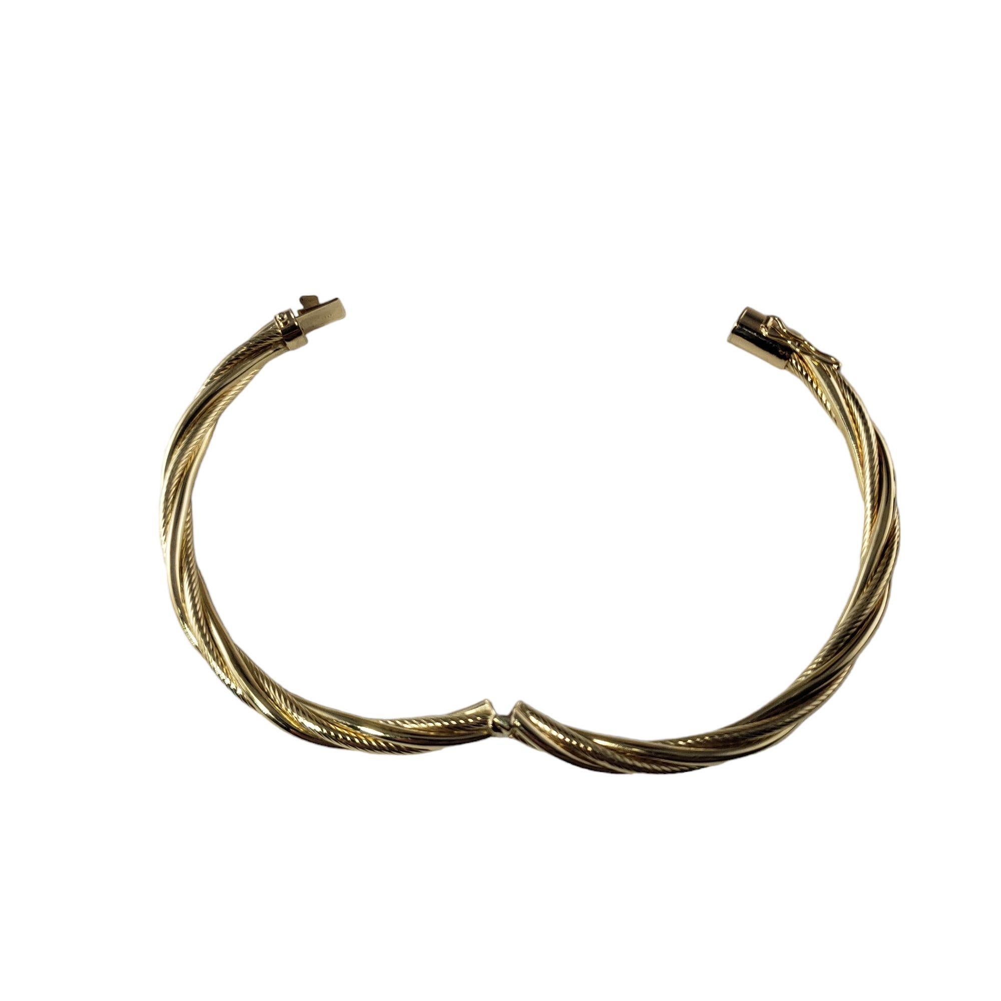 Vintage 14 Karat Yellow Gold Twist Bangle Bracelet-

This lovely hinged twist bangle bracelet is crafted in beautifully detailed 14K yellow gold. Width: 5 mm.

Size: 7 inches

Weight: 6.6 dwt. / 10.4 gr.

Stamped: 14K PAT4170809

Very good