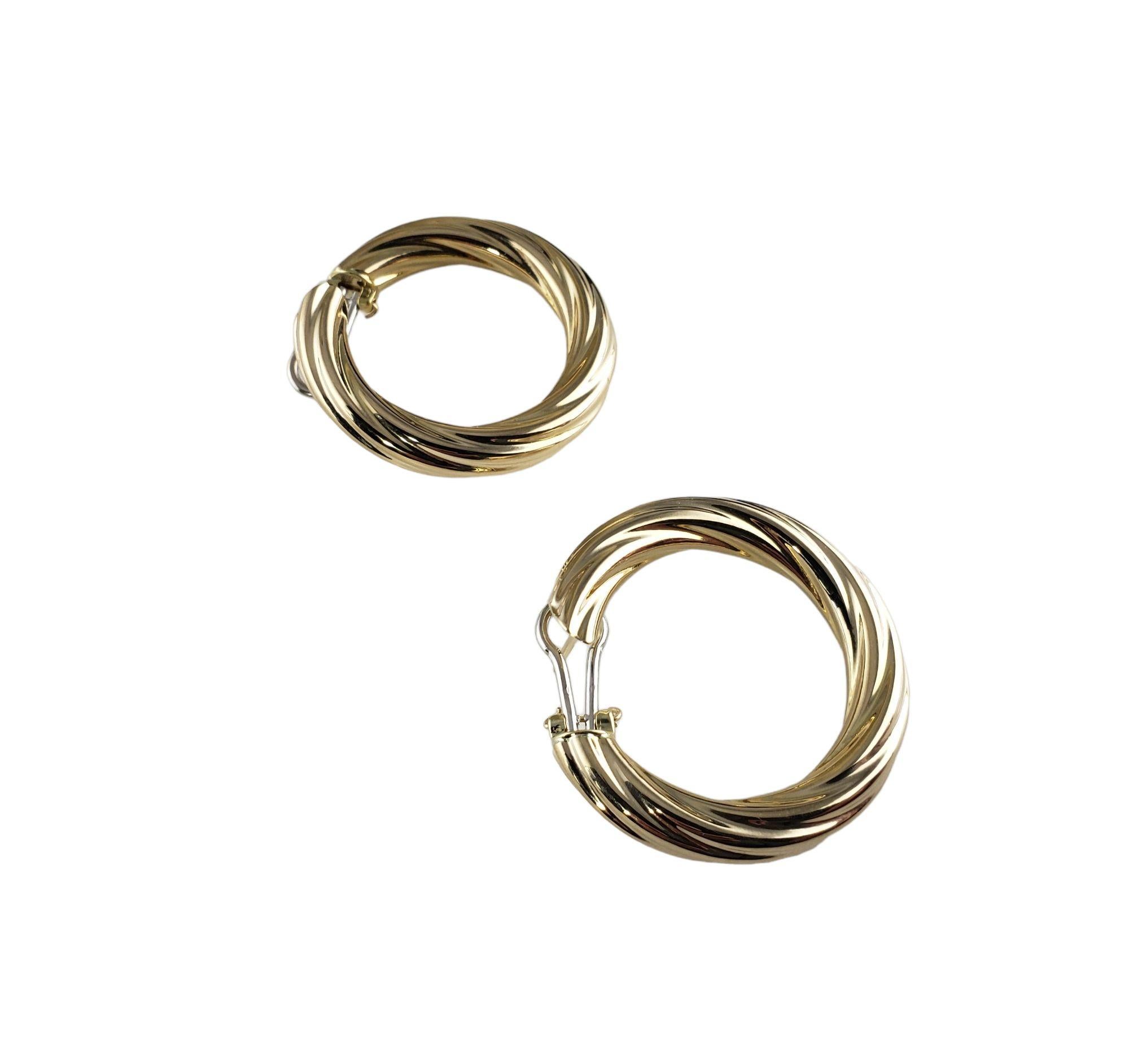 Vintage 14 Karat Yellow Gold Twist Hoop Earrings-

These elegant front-facing hoop earrings are crafted in beautifully detailed 14K yellow gold. Omega back closures.

Size: 34 mm x 6 mm

Weight: 5.4 dwt. / 8.4 gr.

Stamped: UNOAERRE 14K Italy

Very