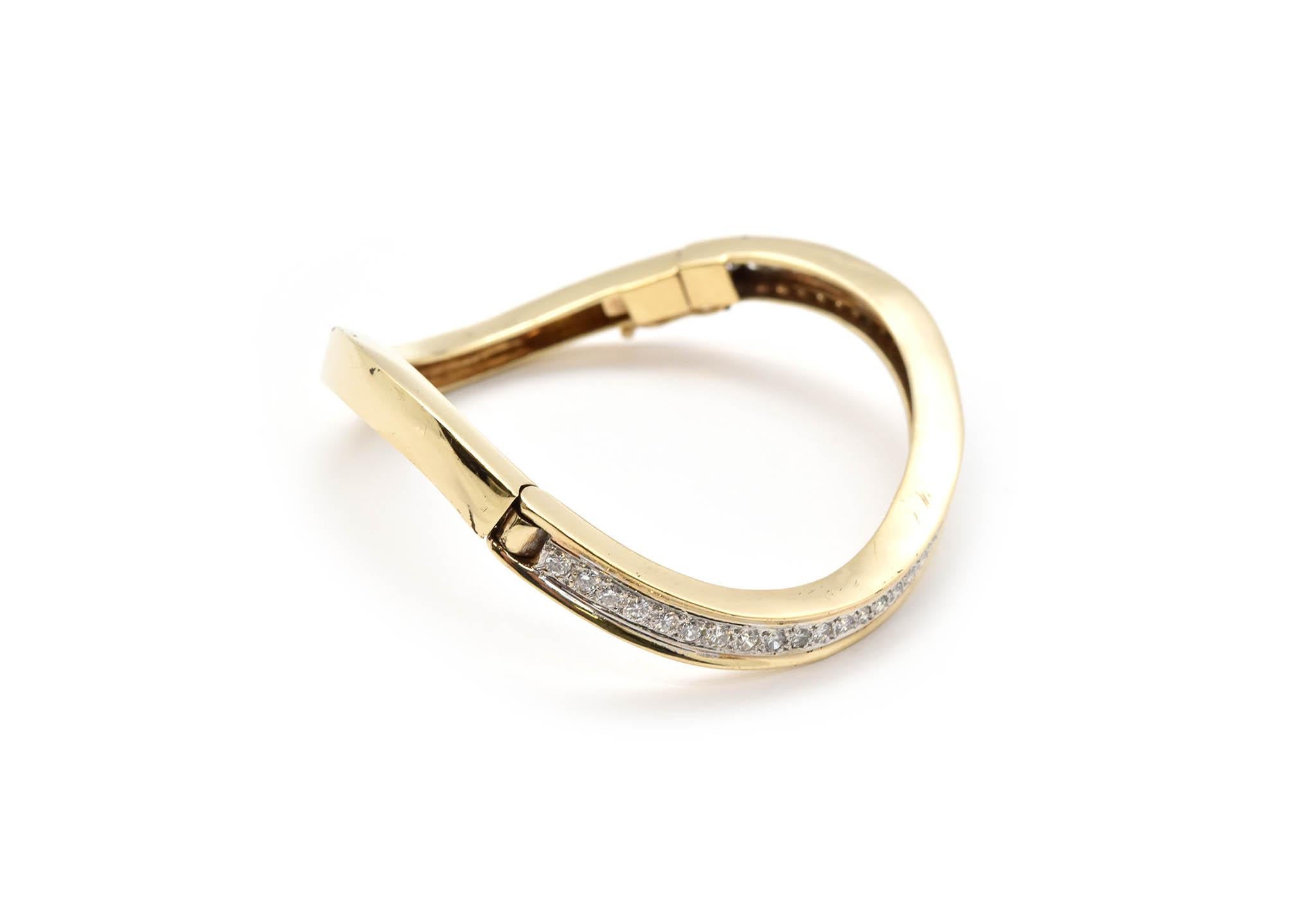 This twisted hinged bangle bracelet is composed of 14k yellow gold and 42 round brilliant VS diamonds! The bracelet is twisted and opens on hinges, making it perfect fit for the wrist! The 42 round diamonds are 1.68cttw and set on prongs, diamonds