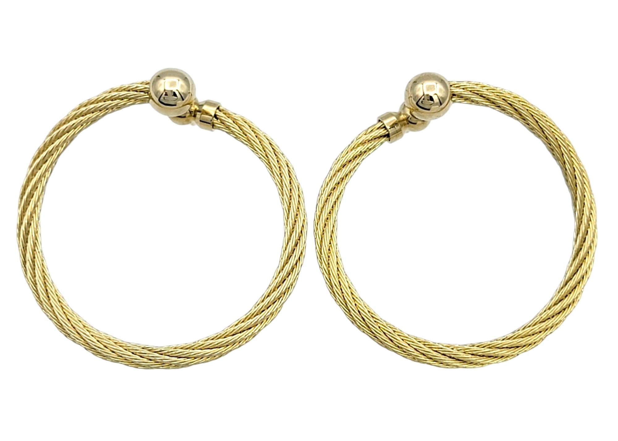 Enhance your elegance with these stunning yellow gold twisted cable front-facing hoop earrings. These earrings feature a sophisticated twisted cable pattern, adding a modern flair to the classic hoop design. The front-facing style ensures they catch