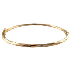 14 Karat Yellow Gold Twisted Oval Bangle Bracelet #19007