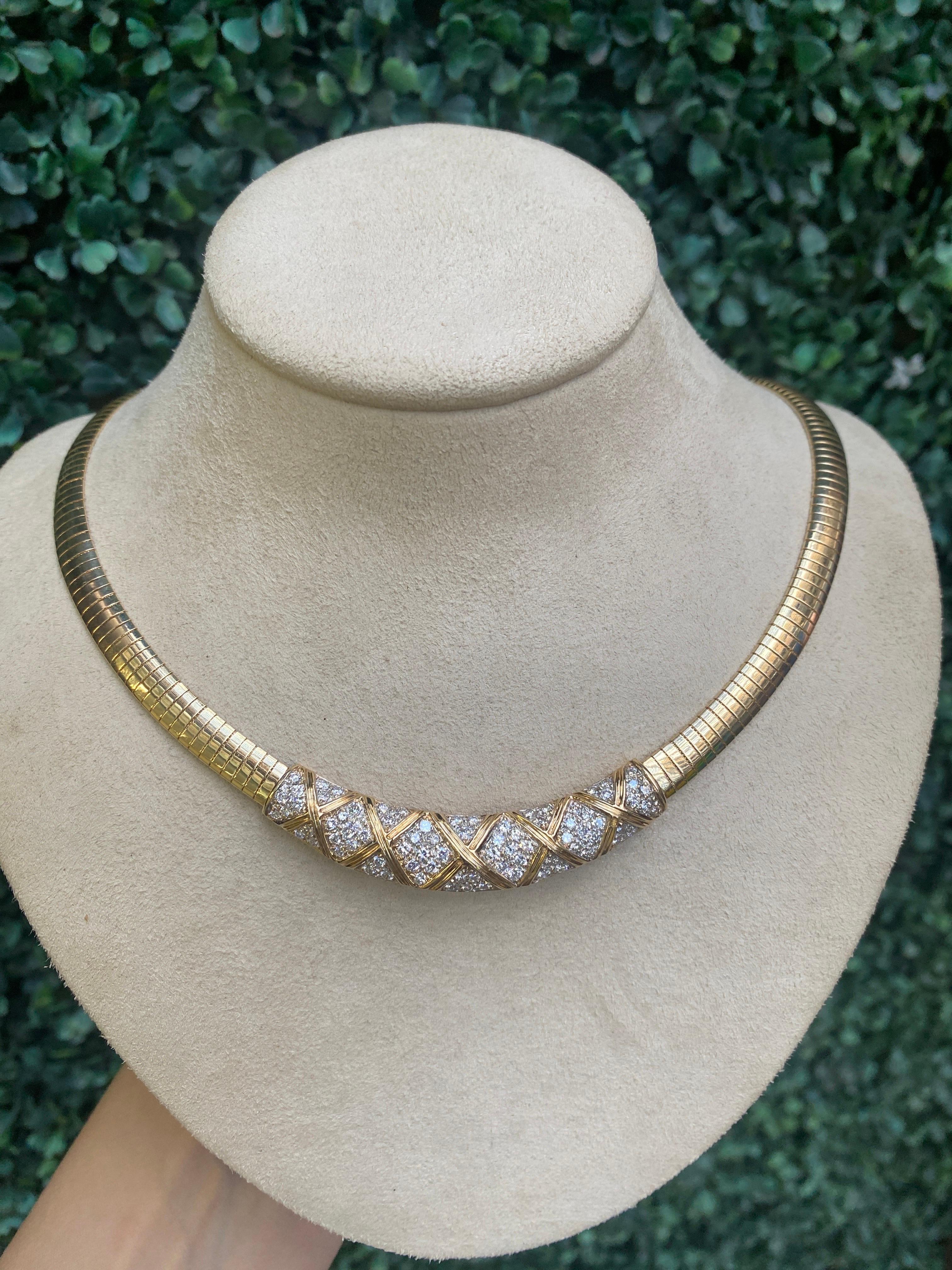 This vintage omega necklace features a station of 2.40 carat total weight in natural round diamonds centered and set in 14 karat yellow gold. Box clasp with safety. 
Condition: Very good. Typical of wear and age.