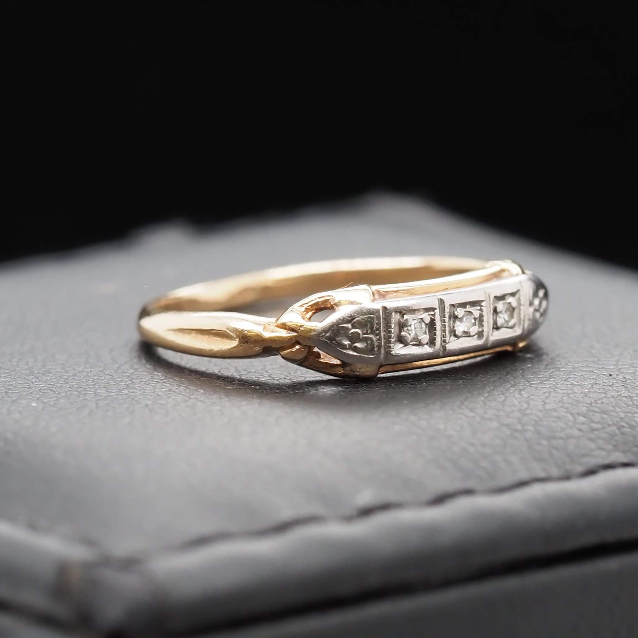 Year: 1930s

Item Details:
Ring Size: 3.75
Metal Type: 14K Yellow Gold [Hallmarked, and Tested]
Weight: 1.0 grams

Diamond Details: .05ct total weight, transitional antique cut, G-H Color, SI Clarity

Band Width: 1.4mm
Condition: Excellent
