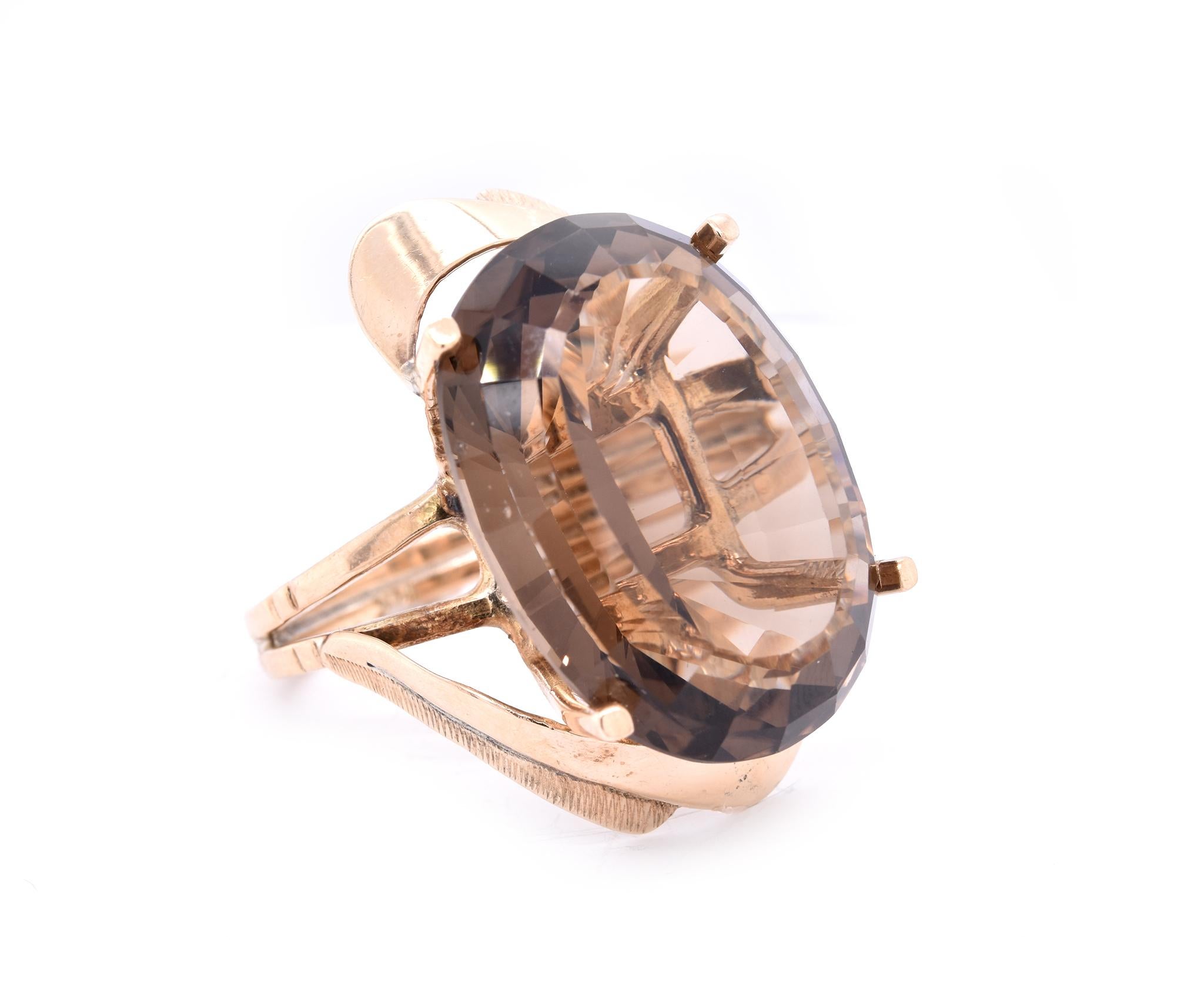 Designer: custom
Material: 14K yellow gold
Smoky Topaz: 1 oval cut = 38.09ct
Ring Size: 8 (please allow up to 2 additional business days for sizing requests)
Dimensions: ring top measures 30.94mm X 20.66mm
Weight:  12.13 grams

