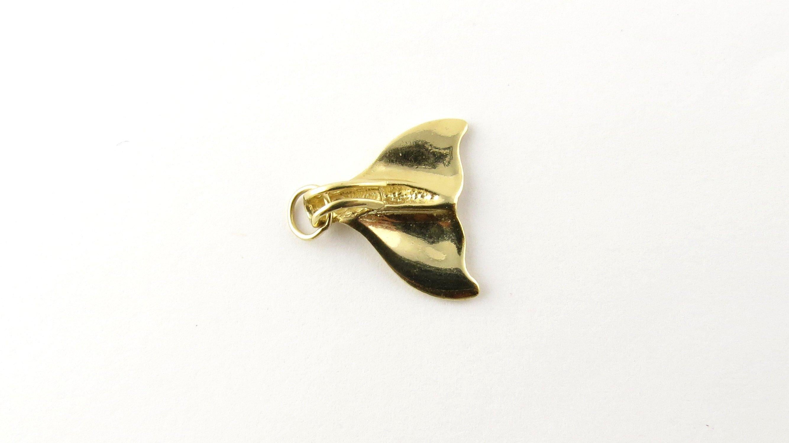 Vintage 14 Karat Yellow Gold Whale Tail Pendant. Whale fins have long symbolized`` good luck, strength and freedom! This lovely pendant features a miniature whale tail meticulously detailed in 14K yellow gold. 
Size: 15 mm x 17 mm Weight: 1.0 dwt. /