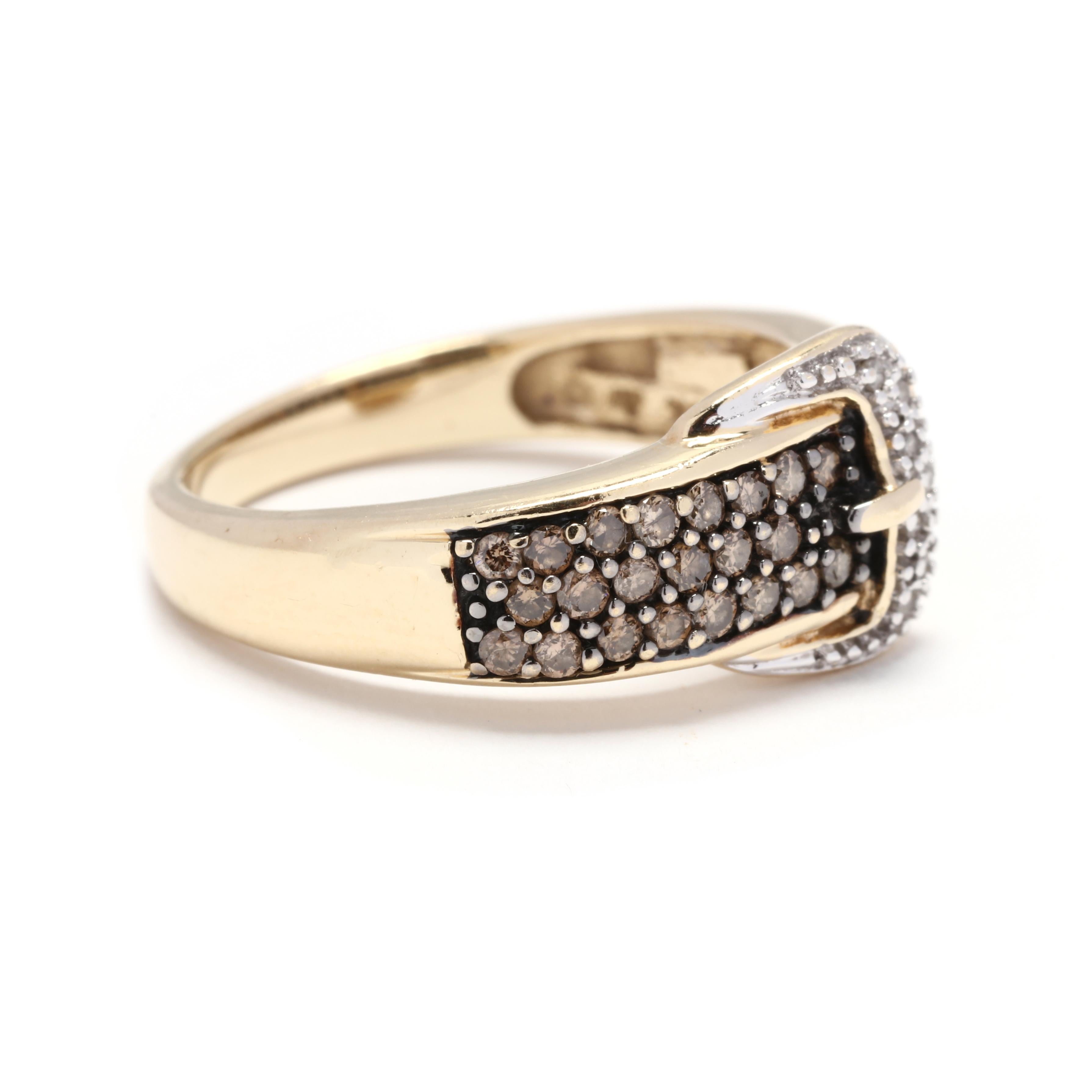 An estate 14 karat yellow and white gold diamond buckle band ring. This ring features a buckle motif design with a white gold clasp set with colorless diamonds and with pavé set light brown diamonds on the shank.



Stones:

- colorless diamonds, 7