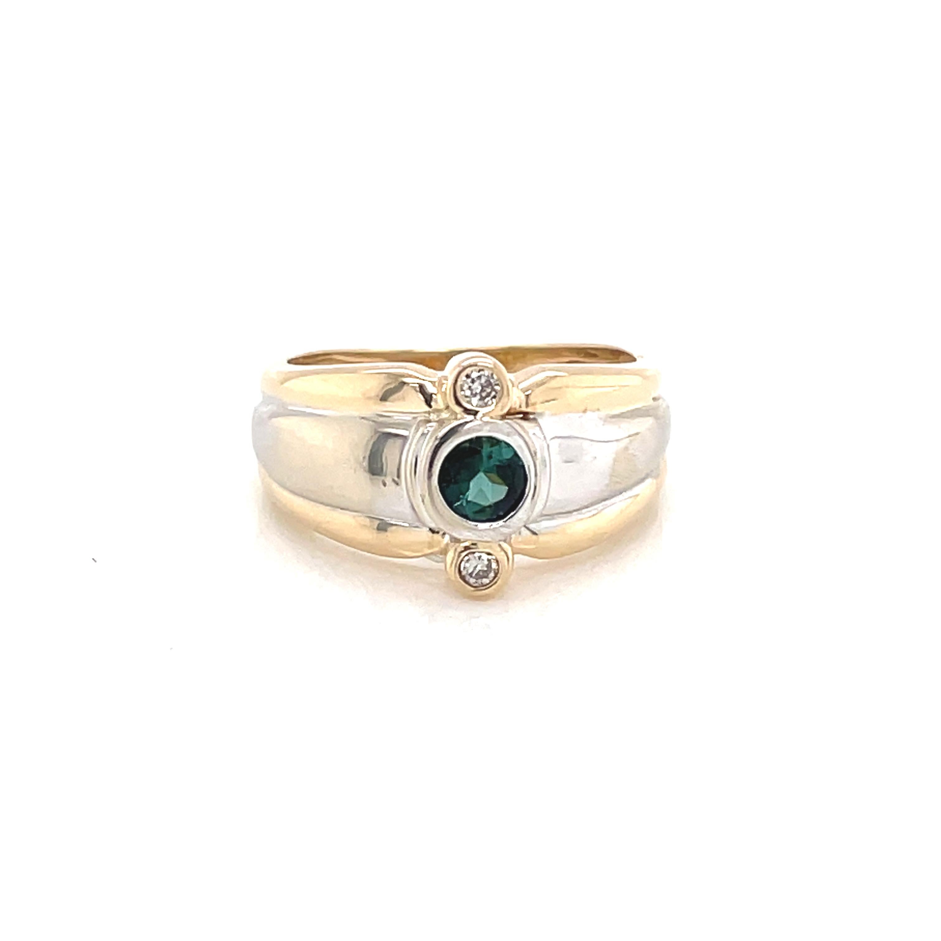 This bright two tone gold ring showcases a vivid 3.25mm round facet cut green beryl center stone on a contemporary style band. The width of the band measures 8.3mm at the face and tapers to 3.70mm in the back. In size 5 and can be resized. Gift