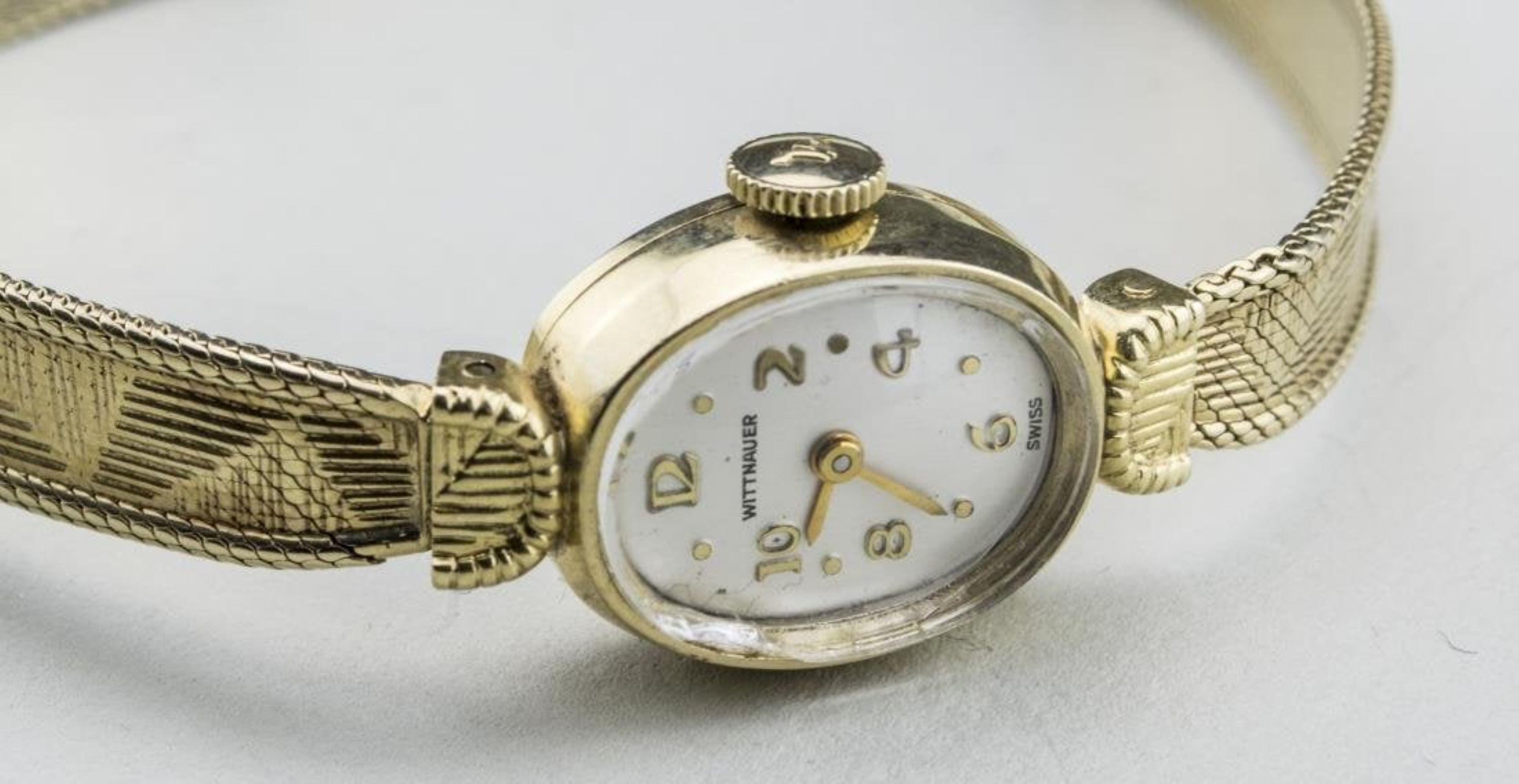 14k yellow gold watch with Arabic and dot hours, gold band marked 585.  Length 6 1/2 inches.