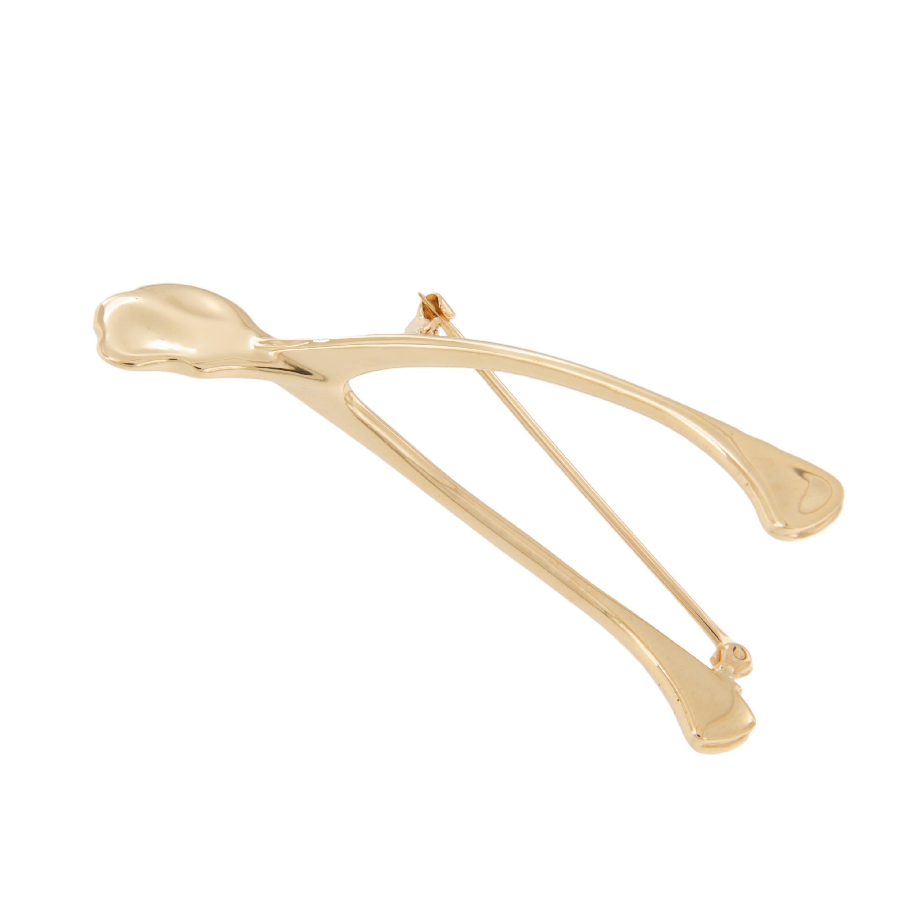 People will be fighting over this wishbone brooch! You could be the lucky owner and wear the legendary bearer of wishes and dreams everyday. Crafted in fine 14 karat yellow gold with expert detail and secure pin with clasp. 2 1/8