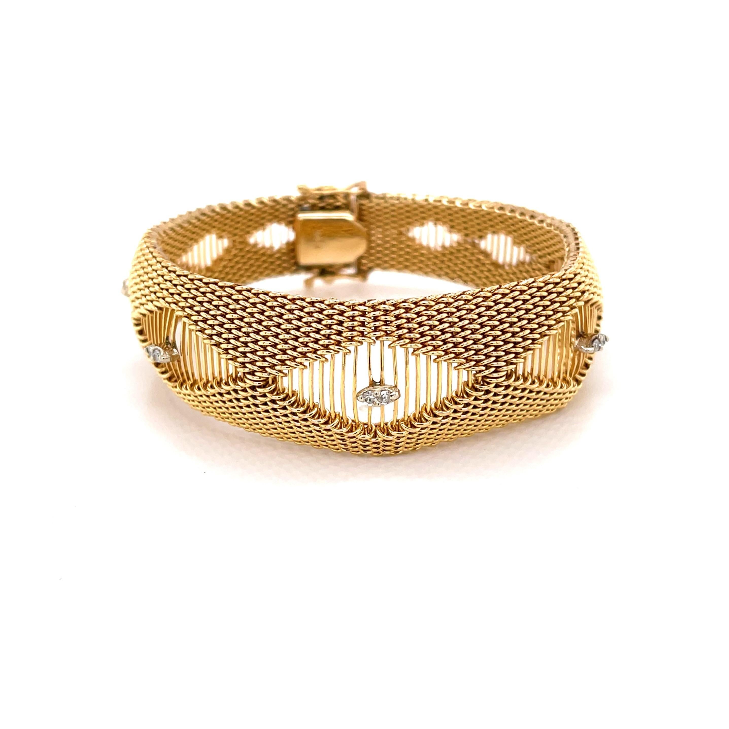 Stylishly sleek with a contoured shape, the patterned tightly woven fourteen karat 14K yellow gold mesh is accented with five unique marquise shaped stations each illuminated with twin diamonds. This stunning bracelet is 7-1/4 inches in length and