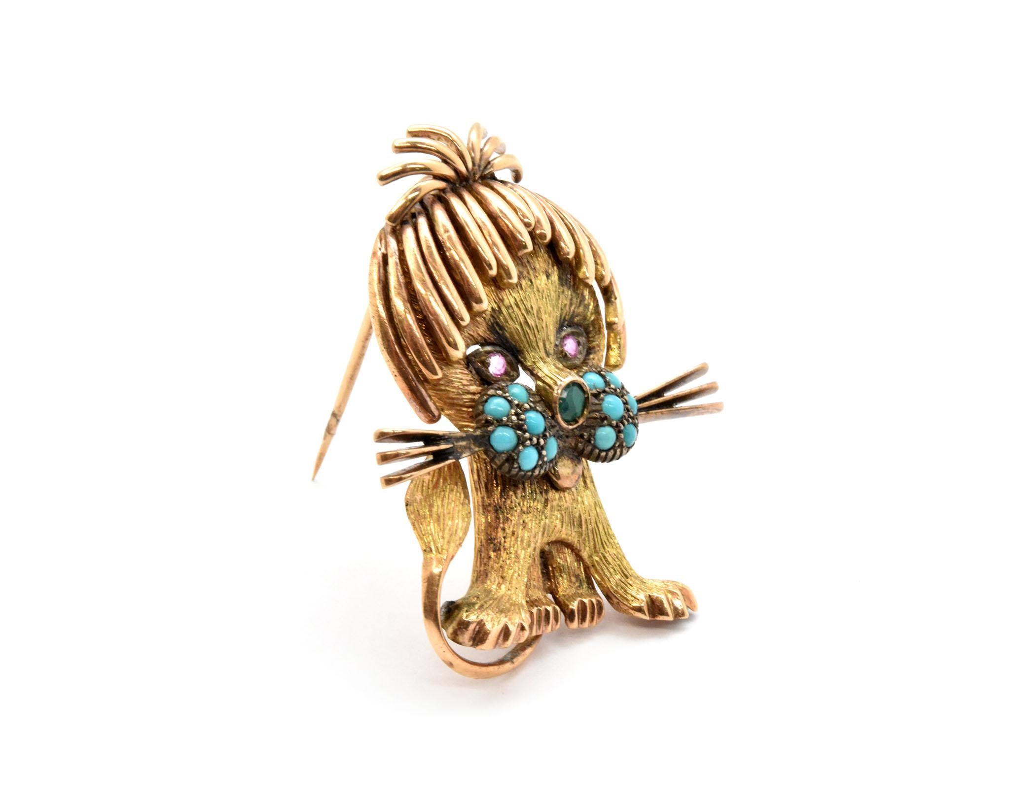 This brooch is made in 14k yellow gold with a 14k rose gold mane. The cat features turquoise beads on his cheeks, and his nose is one emerald. Finally, his eyes are set with single pink sapphires. The brooch measures 41x32mm, and it weighs 13.8