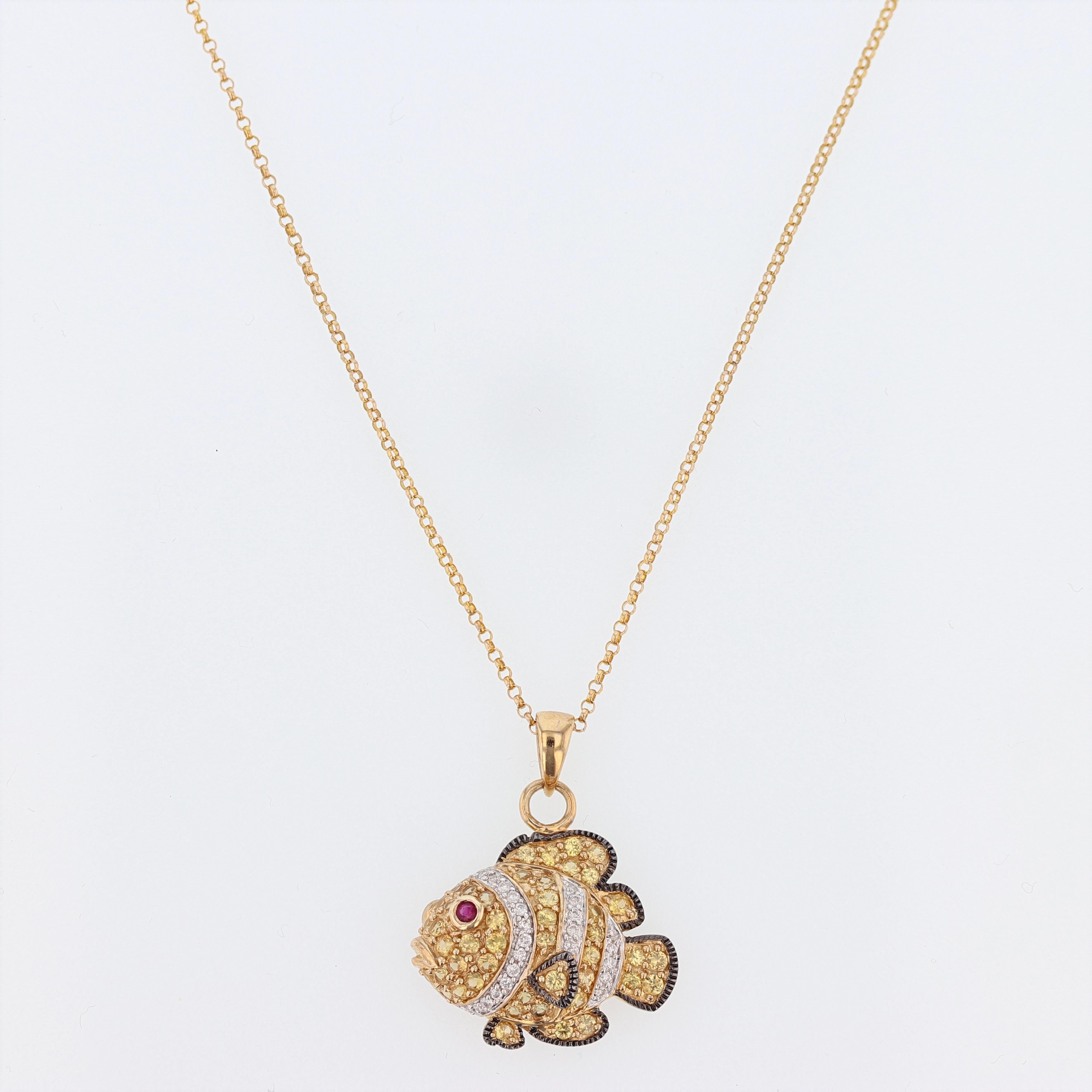 This clown fish pendant is made in 14k yellow gold with a black rhodium finish and features round yellow sapphires weighing 1.10ct prong set. The pendant necklace also features round cut diamonds prong set weighing 0.13ct color grade (I) clarity