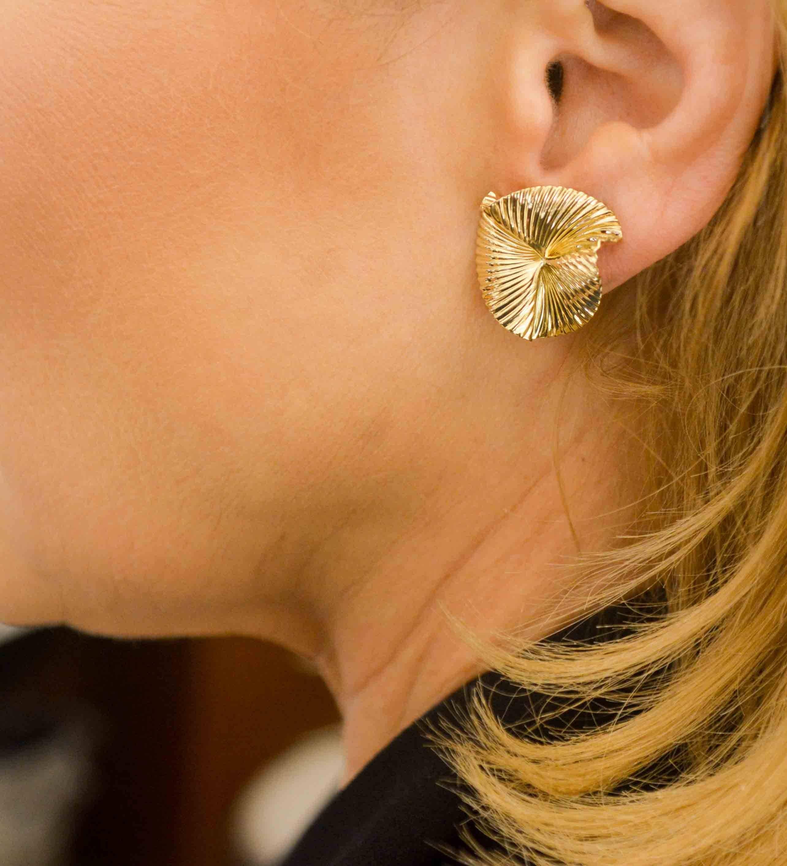 Creating an illusion of a fan, these earrings have a fluid artistic appeal. Go ahead and slip on our swirl style clip back earrings crafted in 14K yellow gold. These earrings are lightweight and versatile but strong enough for everyday wear, and