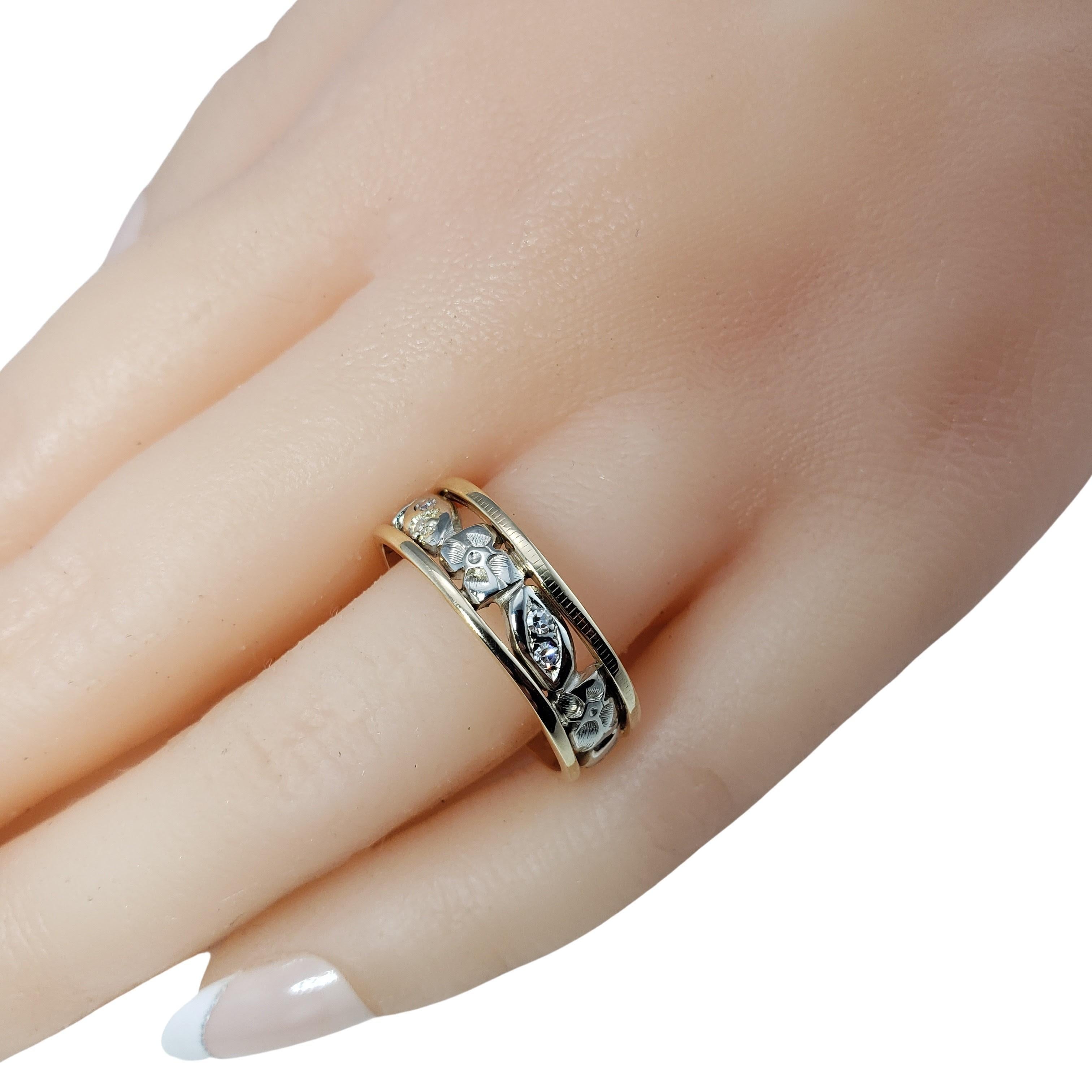 Vintage 14 Karat Yellow/White Gold and Diamond Leaf Pattern Band Ring Size 9.25-

This elegant 14K yellow and white gold ring features a lovely leaf pattern accented with 10 round single cut diamonds. Width: 7 mm.

Approximate total diamond weight: