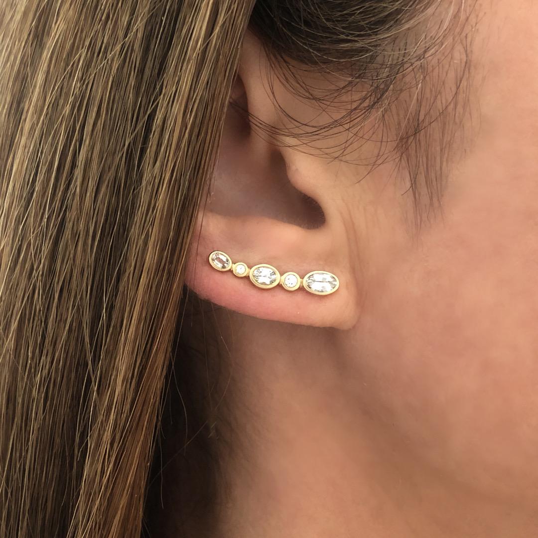 14k YG Elliptic White Sapphire and Diamond Climber Earrings (Dia.0.10cts).  Extended handmade posts help to keep earrings in place.   

The Climber Earring is designed to be an everyday style that can go into the night. This brilliant stone