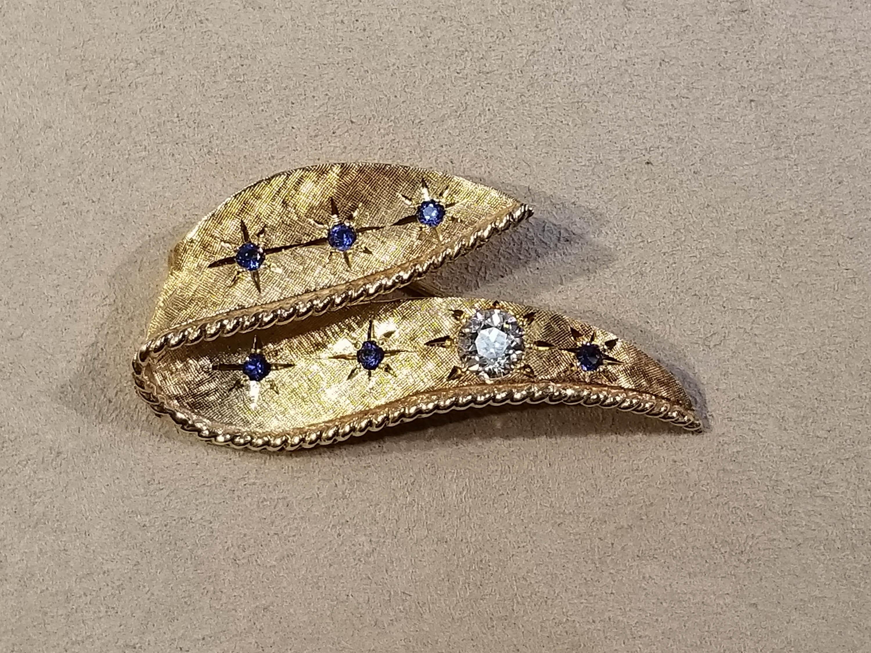14k y/g Sapphire & Diamond Brooch.

Diamond: .50 ct J/K in color and an SI in clarity.

1 5/8 inches long, 11/16 inches tall at highest point. 