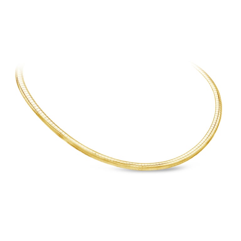 This polished omega chain necklace is 16 inches in length made in 14 karats yellow gold and weighs 20.56 grams.