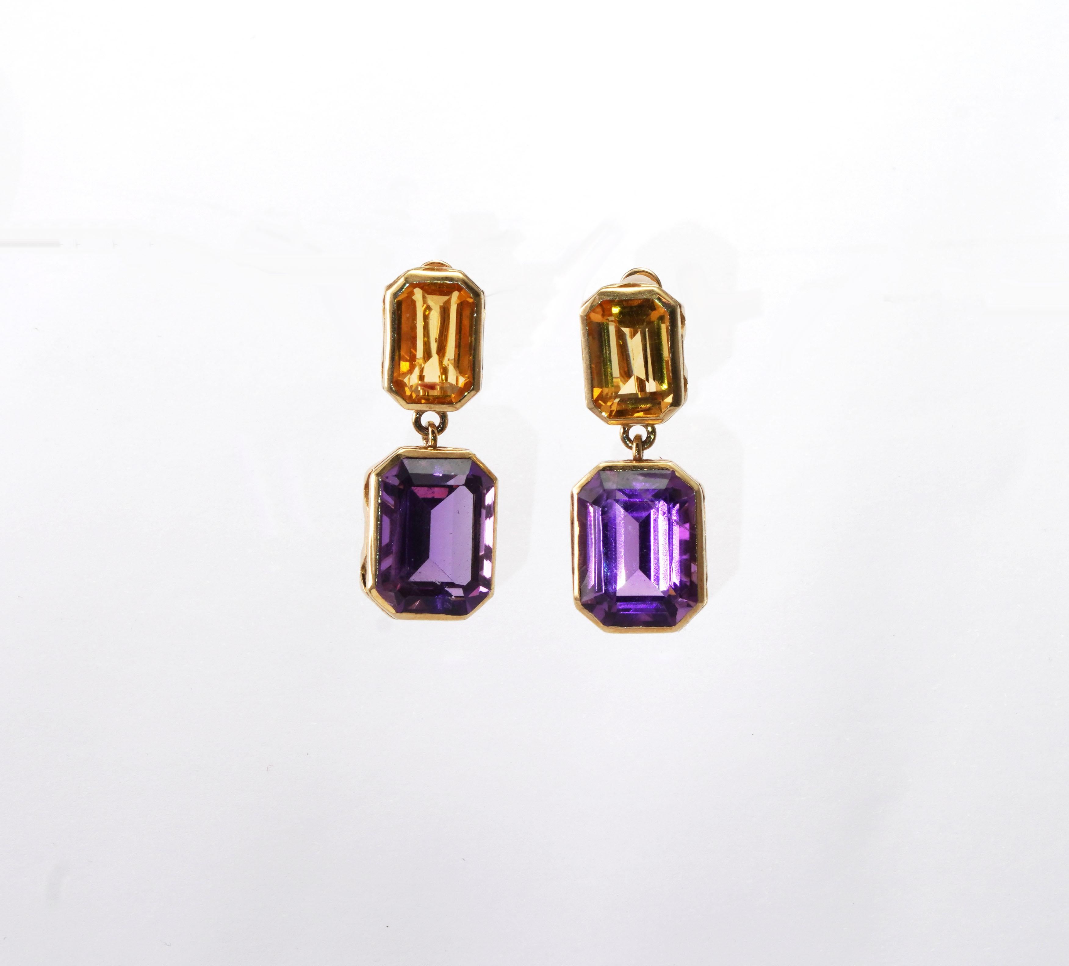 14 kt gold pair of earrings with Amethyst and Citrine 
Gold color: Yellow
Dimensions: 31 mm length
Total weight: 4.44 grams

Set with:
- Amethyst
Cut: Emerald
Weight: 10.7 ct
Color: Purple

- Citrine
Cut: Emerald
Weight: 3.60 ct
Color: Yellow